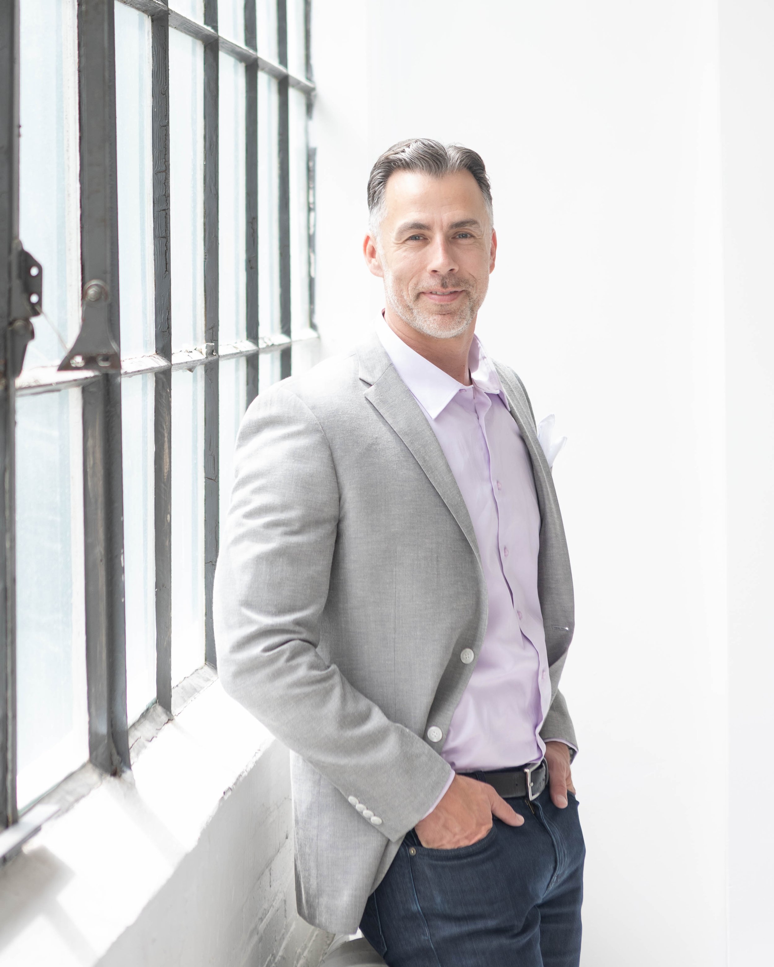 tv executive standing by window, personal-brand-photography-3142.jpg