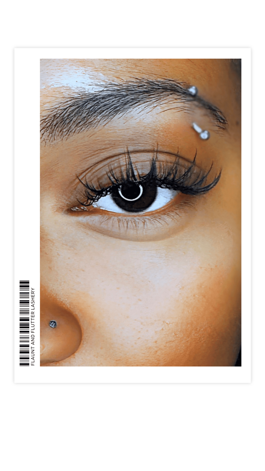 Close-up of a woman's eye with makeup, including eyeliner, mascara, and pierced eyebrow with two jewelry studs, and a pierced nose with a small stud. The background shows part of her skin and face.