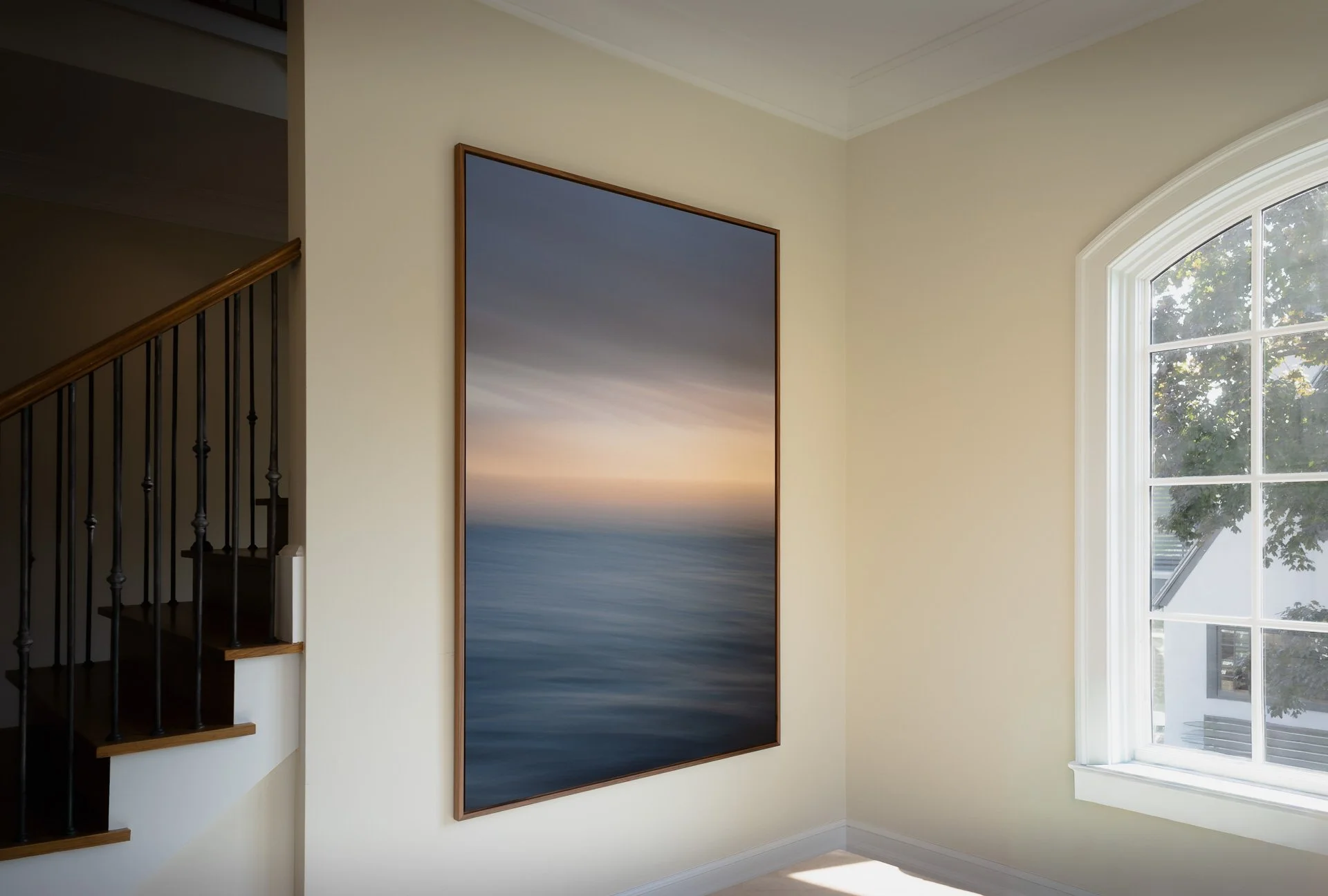 Break in the Sky on a dining room wall between a staircase and an arched window in a home in Rye, New York