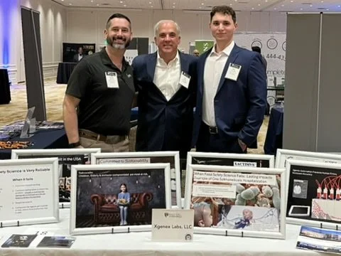 Xgenex representatives at a poultry industry trade show booth. 