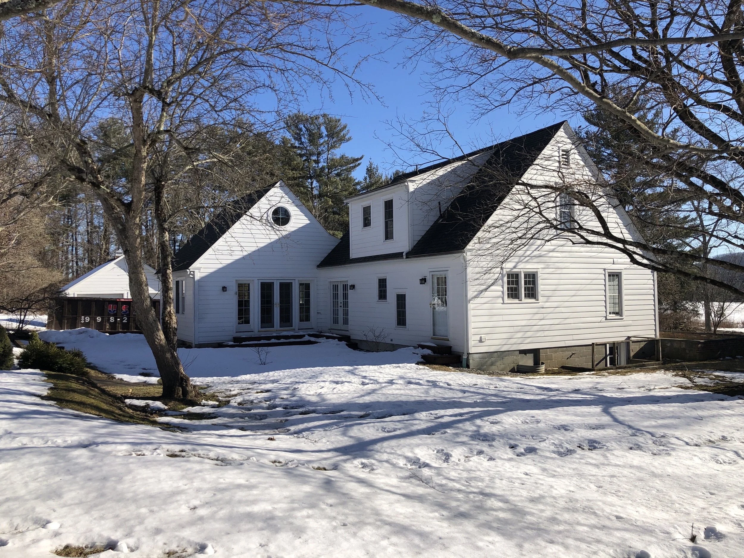 Before: The back of the house was a mishmash of doors, without a dedicated outdoor space or patio.