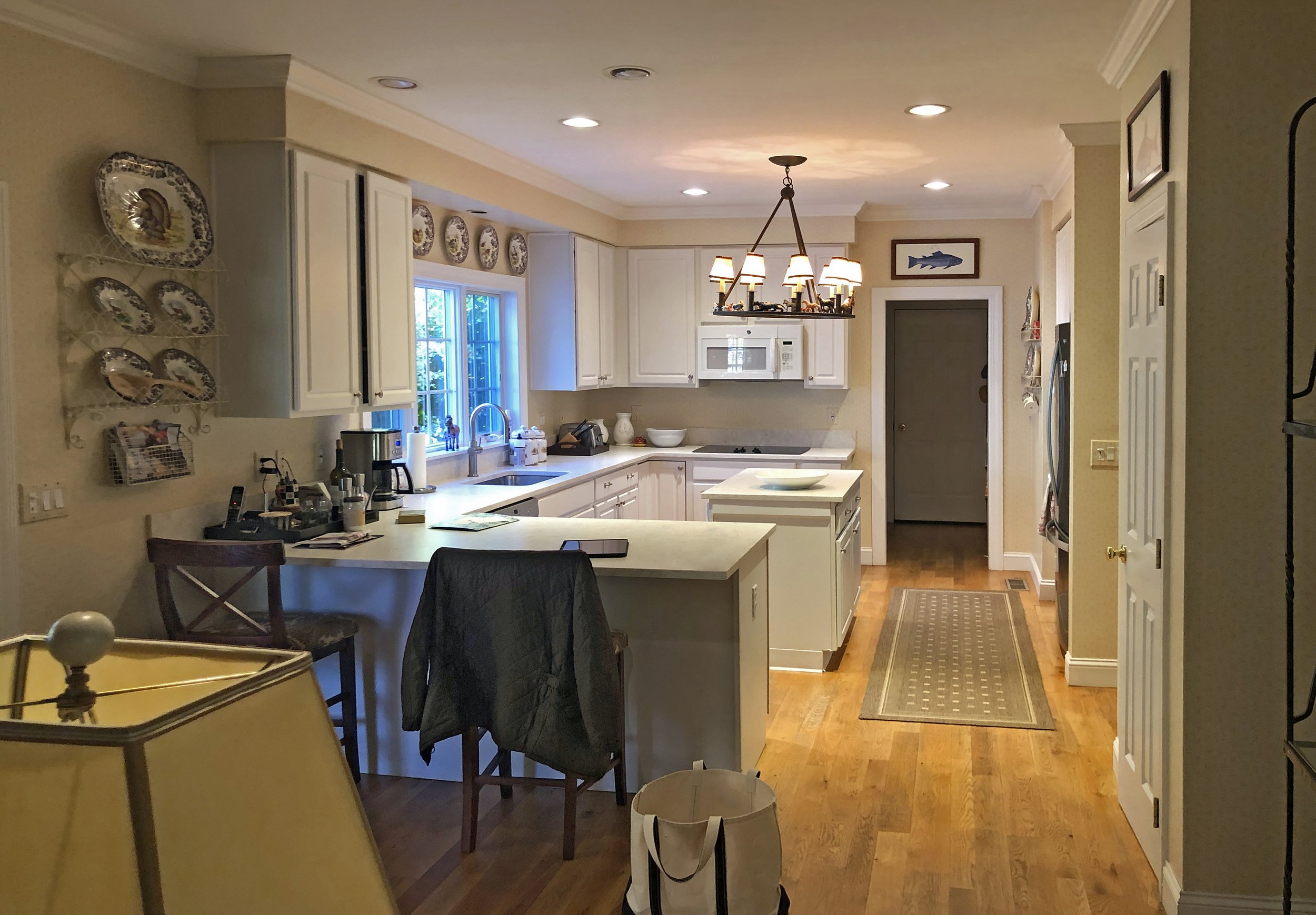 Before: Standard cabinetry, beige walls, and dated lighting in the original kitchen.