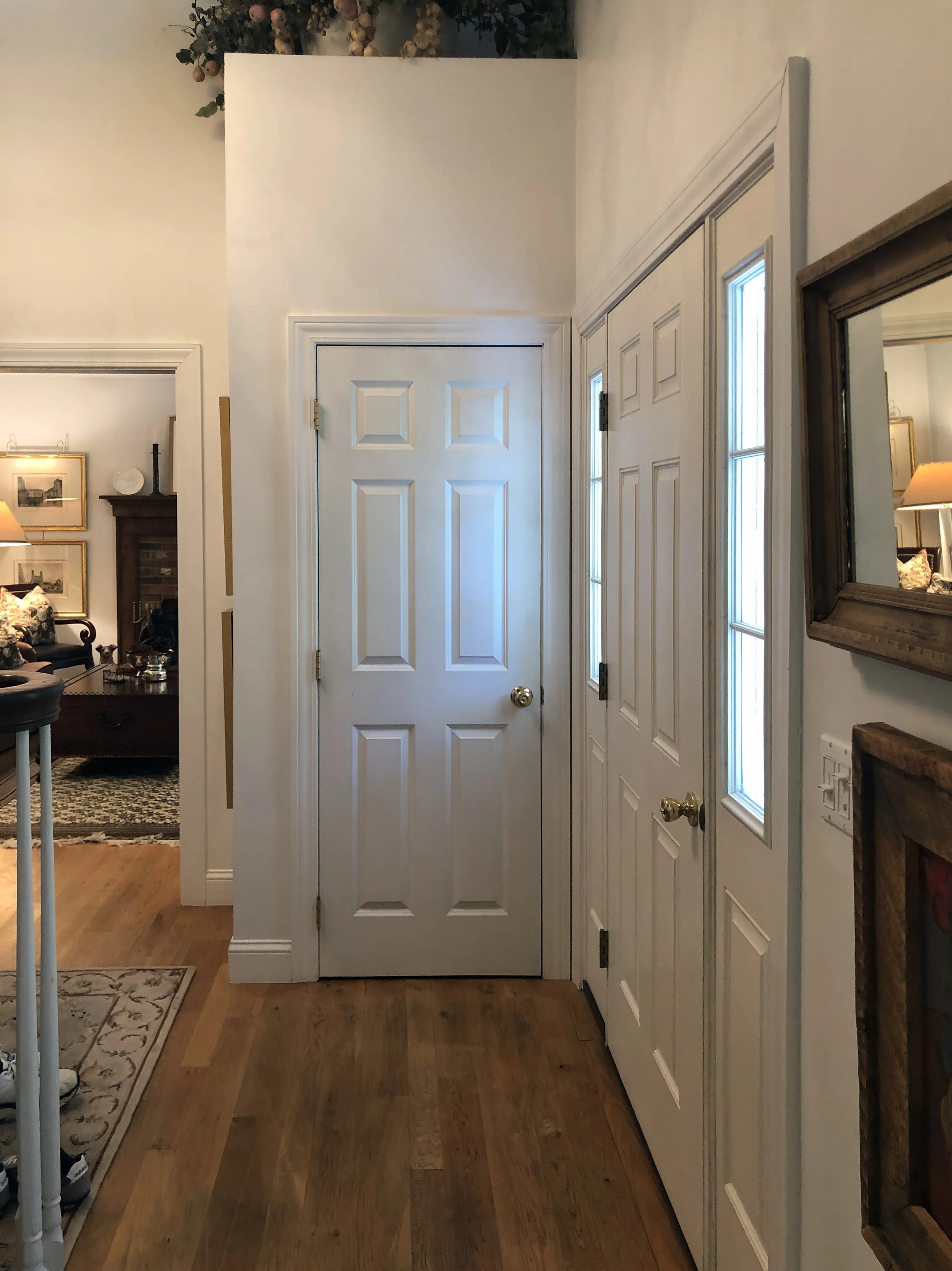 Before: The original foyer felt confined, with an underutilized closet that disrupted the flow and limited the sense of openness.
