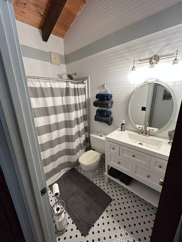 Bathroom remodel including tiling, vanity install, panel installed on walls and painted.