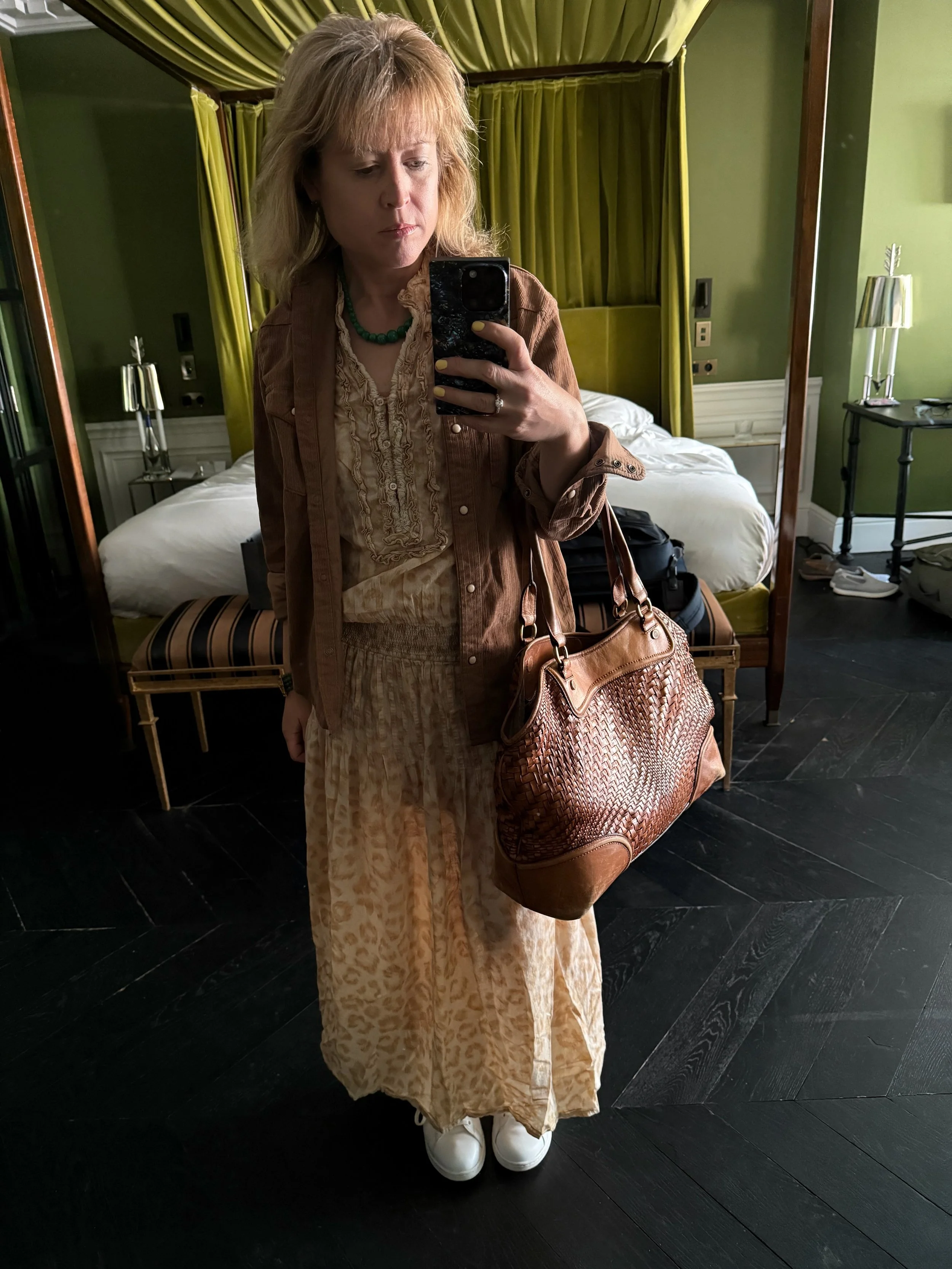 DVF Lily silk maxi dress worn by caucasian woman in hallway reflected in mirror