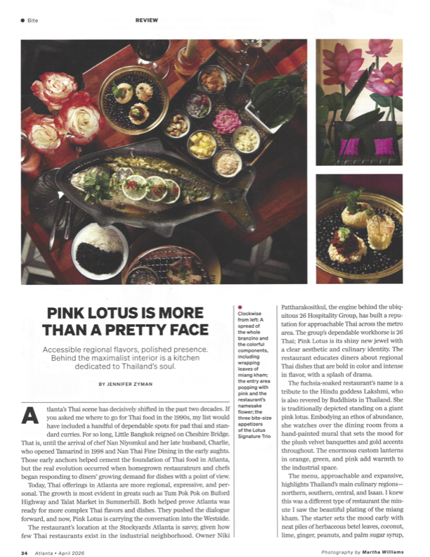 Top-down view of a whole branzino and Thai dishes at Pink Lotus Thai Restaurant with colorful interior details and decorative elements in Atlanta