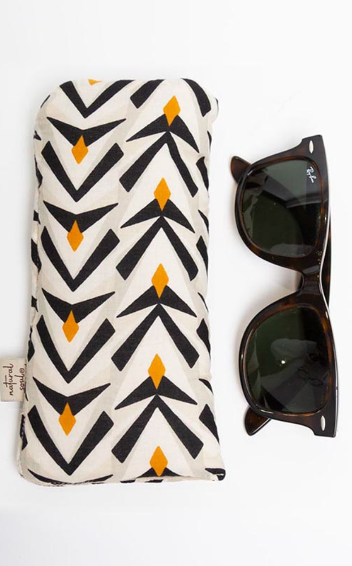 A black and white patterned glasses case with yellow diamond shapes next to a pair of black sunglasses with a logo on the arm, all on a white background.