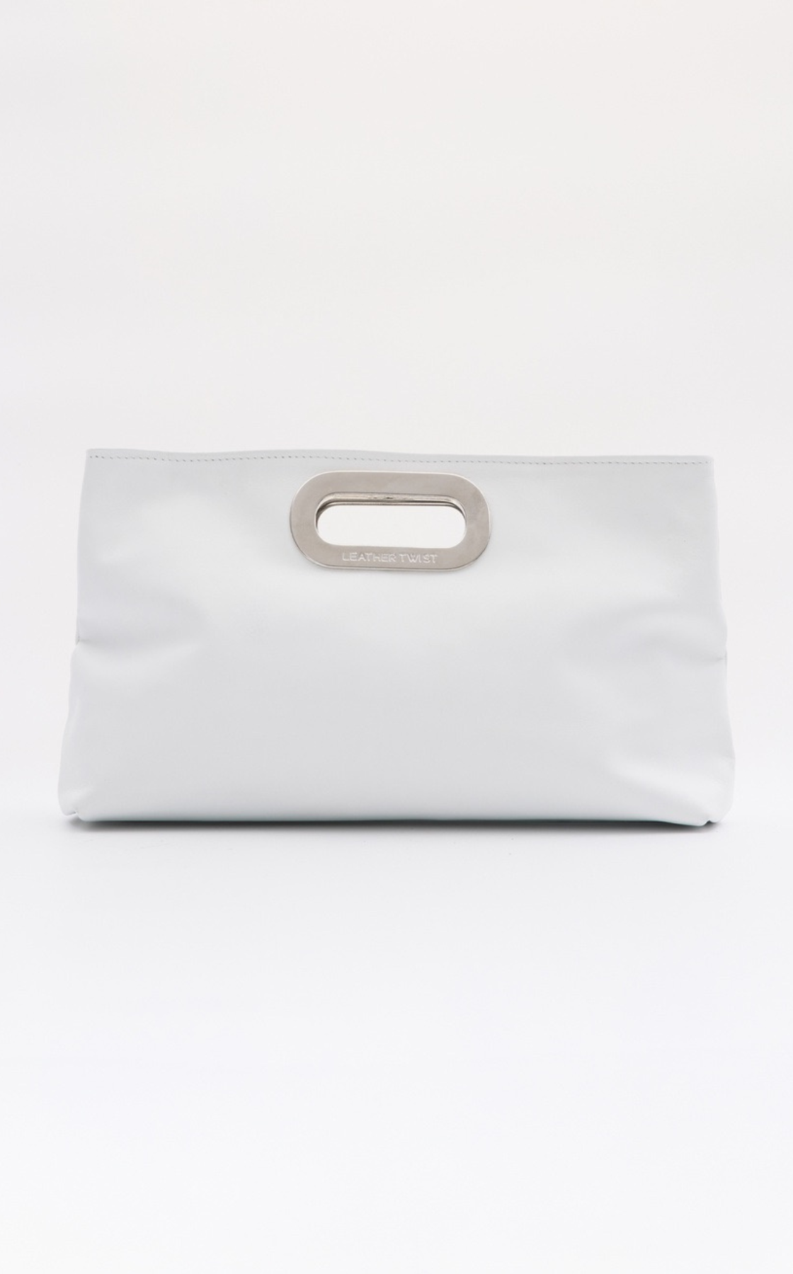 A white handbag with a metallic handle that says 'LEATHER TWIST' on a plain white background.