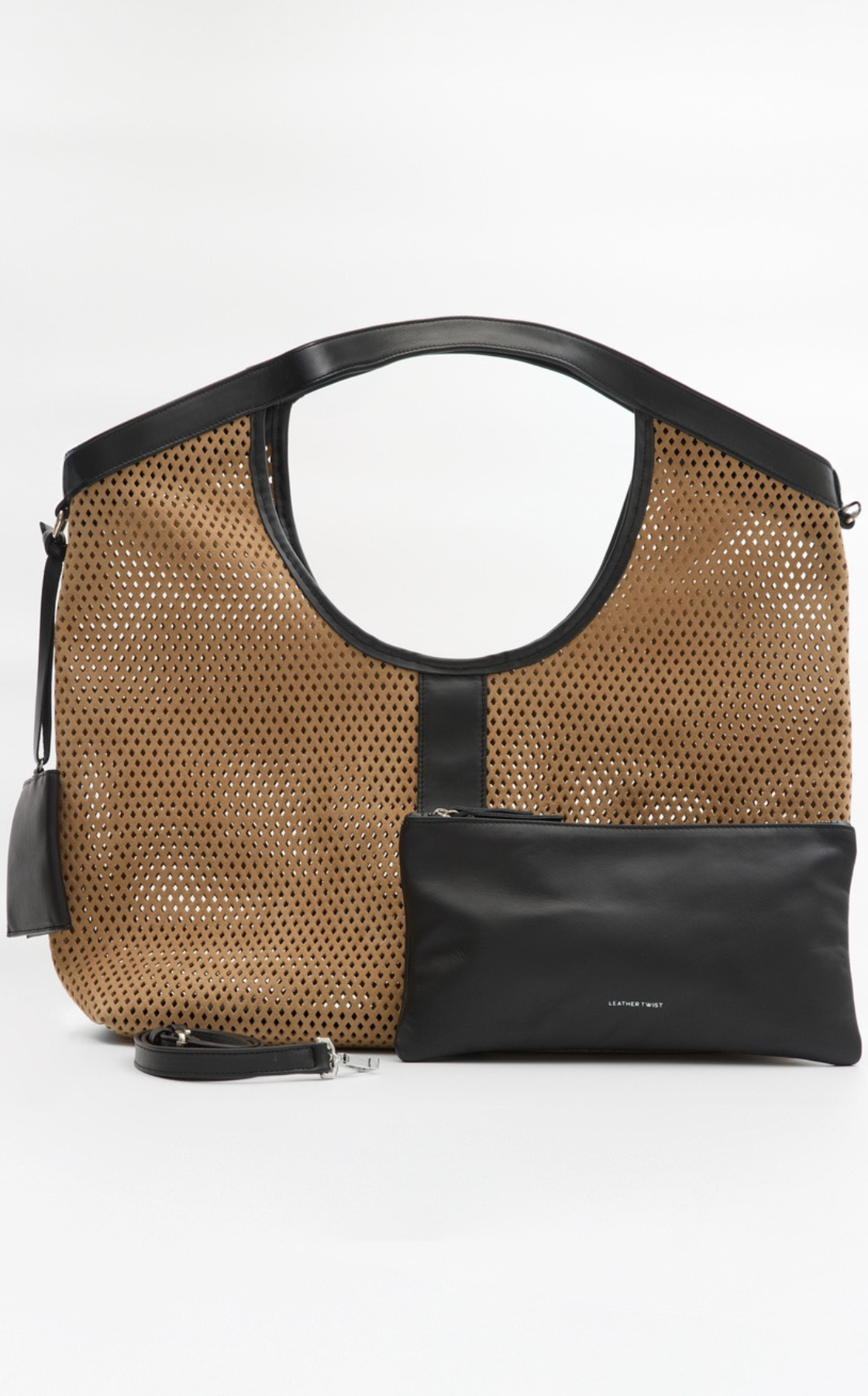 A large tan and black perforated handbag with a circular handle design, a small black pouch attached to the front with the text 'LEATHER TWIST', and a matching black detachable strap.