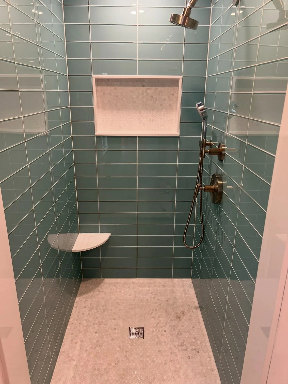 teal and pink tiled shower remodel with seat and double shower head removable shower head