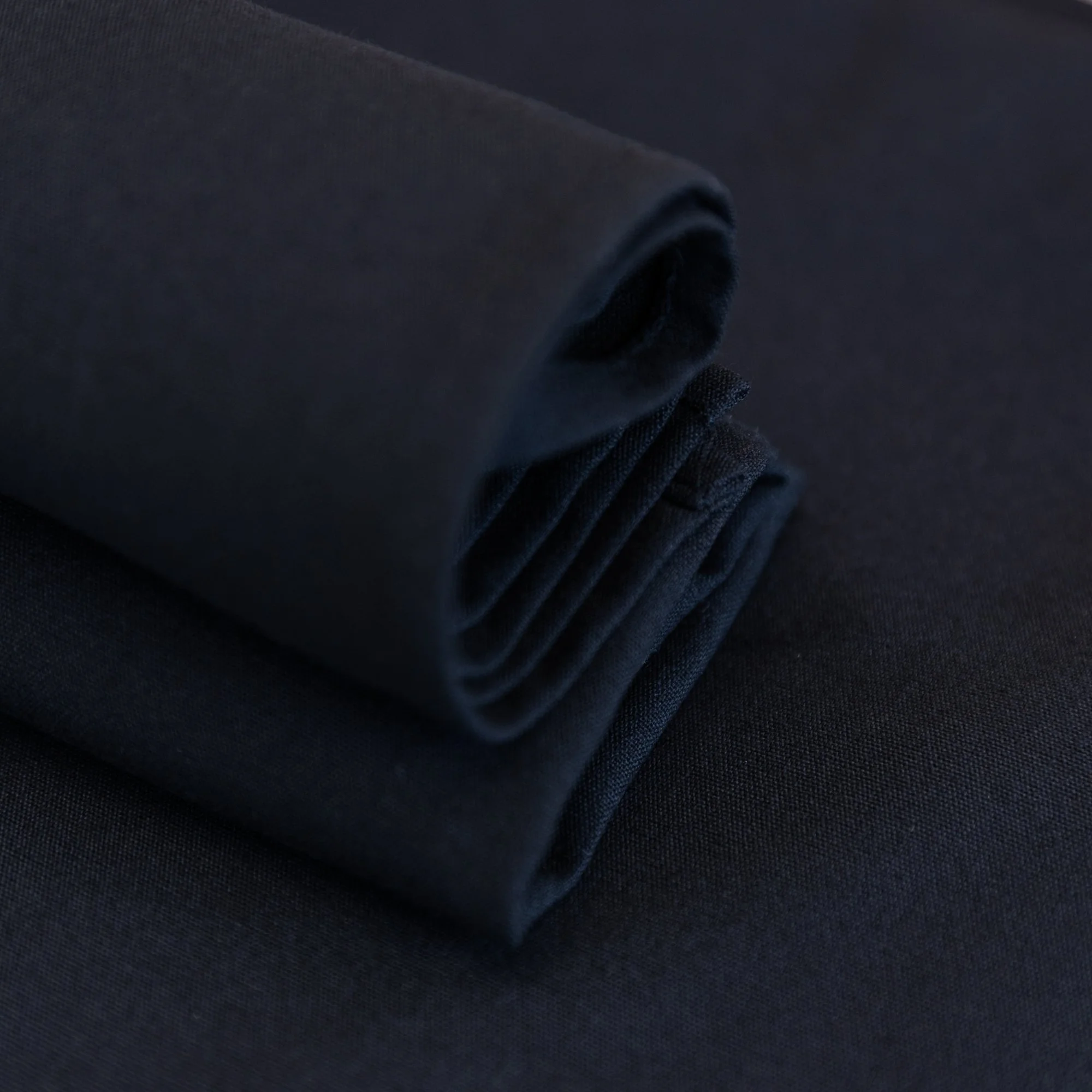 Close-up of ring spun polyester tablecloth drape — stain resistant event linen NZ