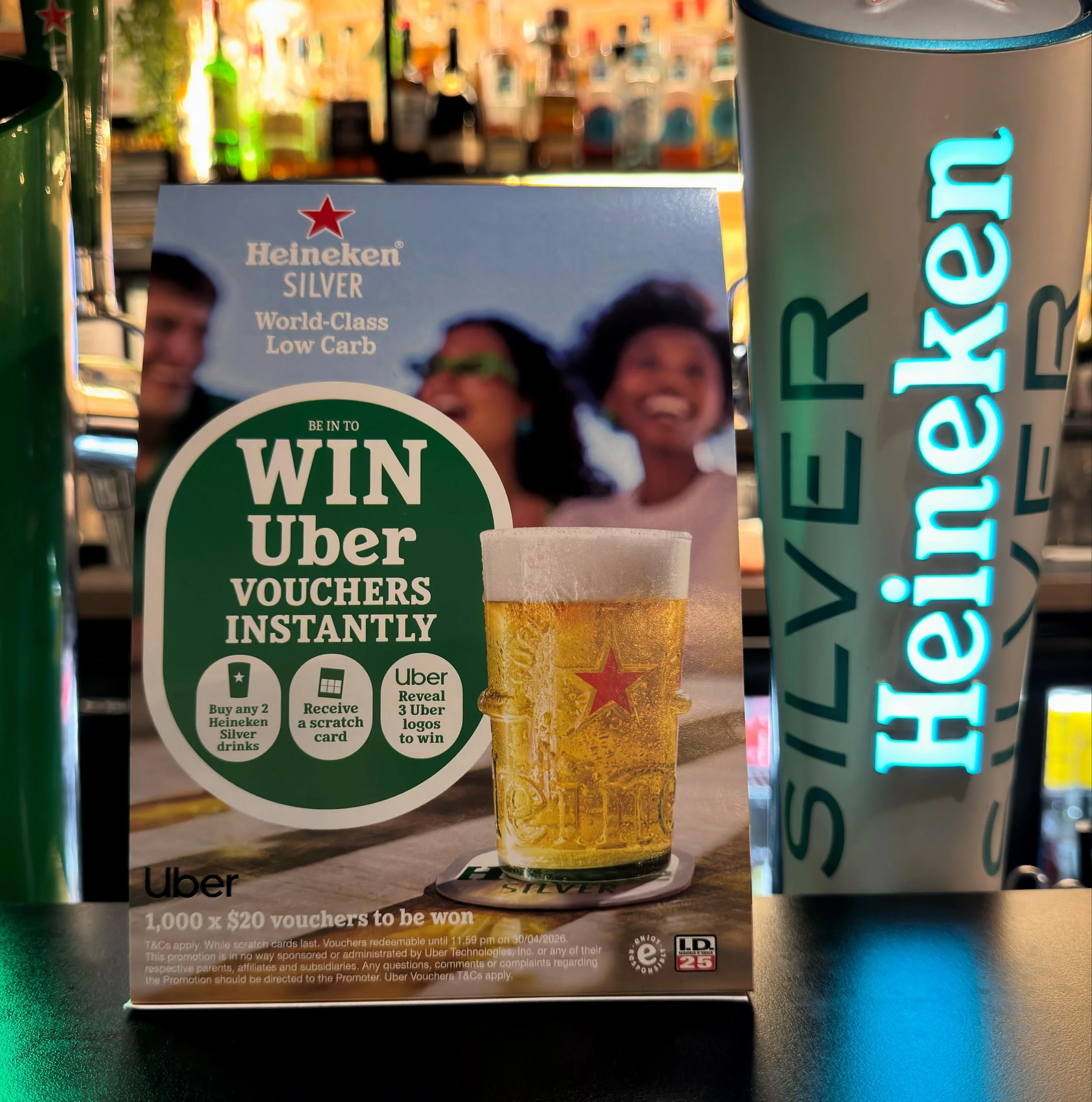 Promotion for Heineken Silver where you have a chance to win 1,000 $20 Uber vouchers by buying two Heineken Silver tap beers and revealing three Uber logos on scratch cards.