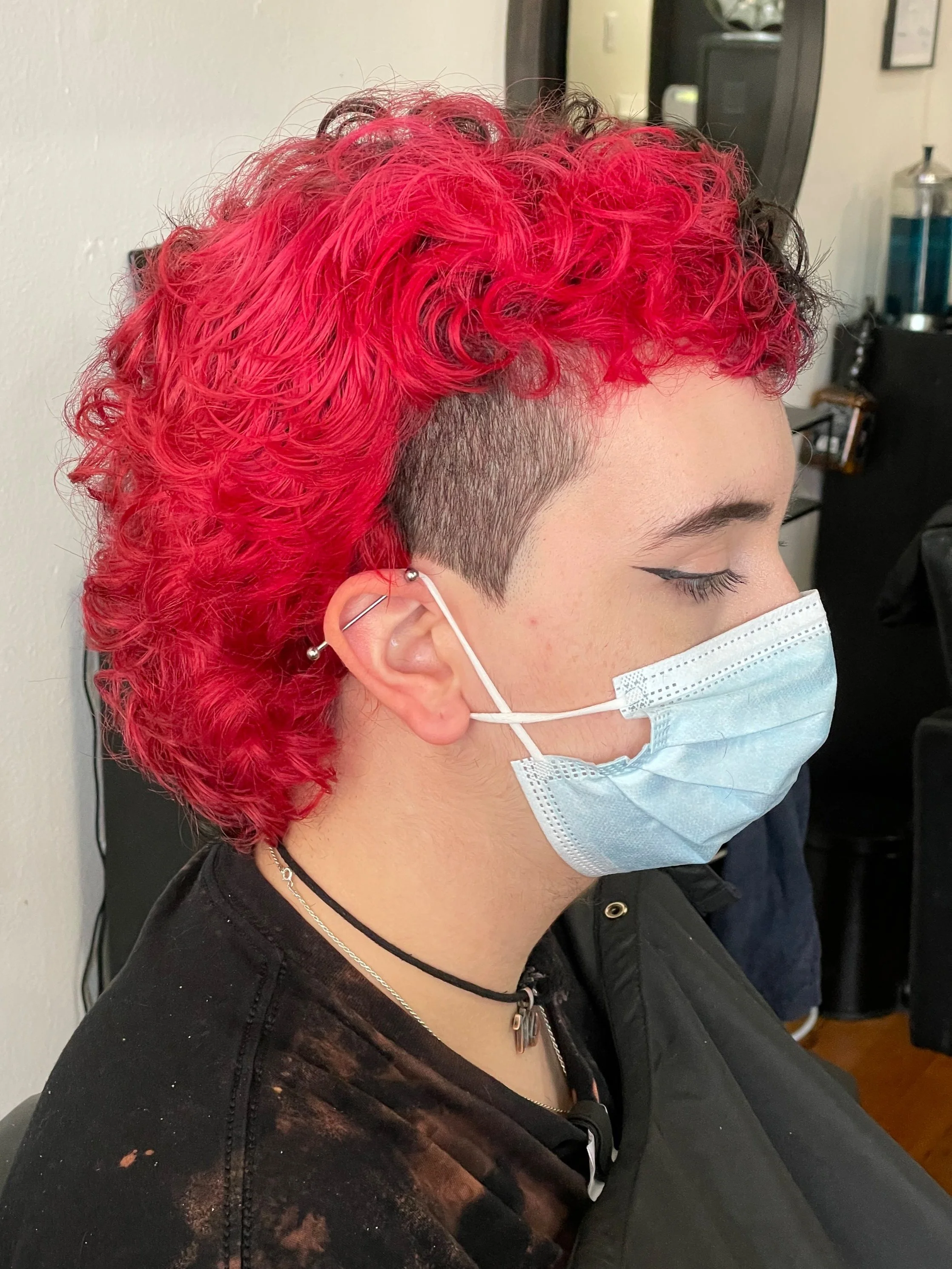 curly wavy red hair short haircut mullet with shaved undercut queer nonbinary haircut