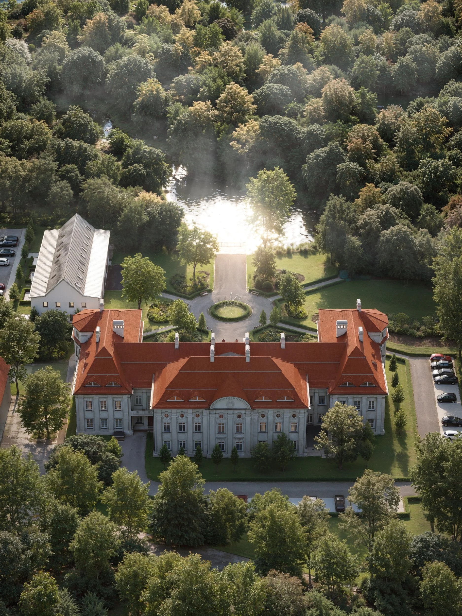 A grand white mansion with a red roof, surrounded by trees and a well-maintained garden with pathways and benches. Kamil Rombczyk portfolio architectural vizualization. Kamil Rombczyk portfolio wizualizacje architektoniczne. Wizualizacja Kamil Rombcz