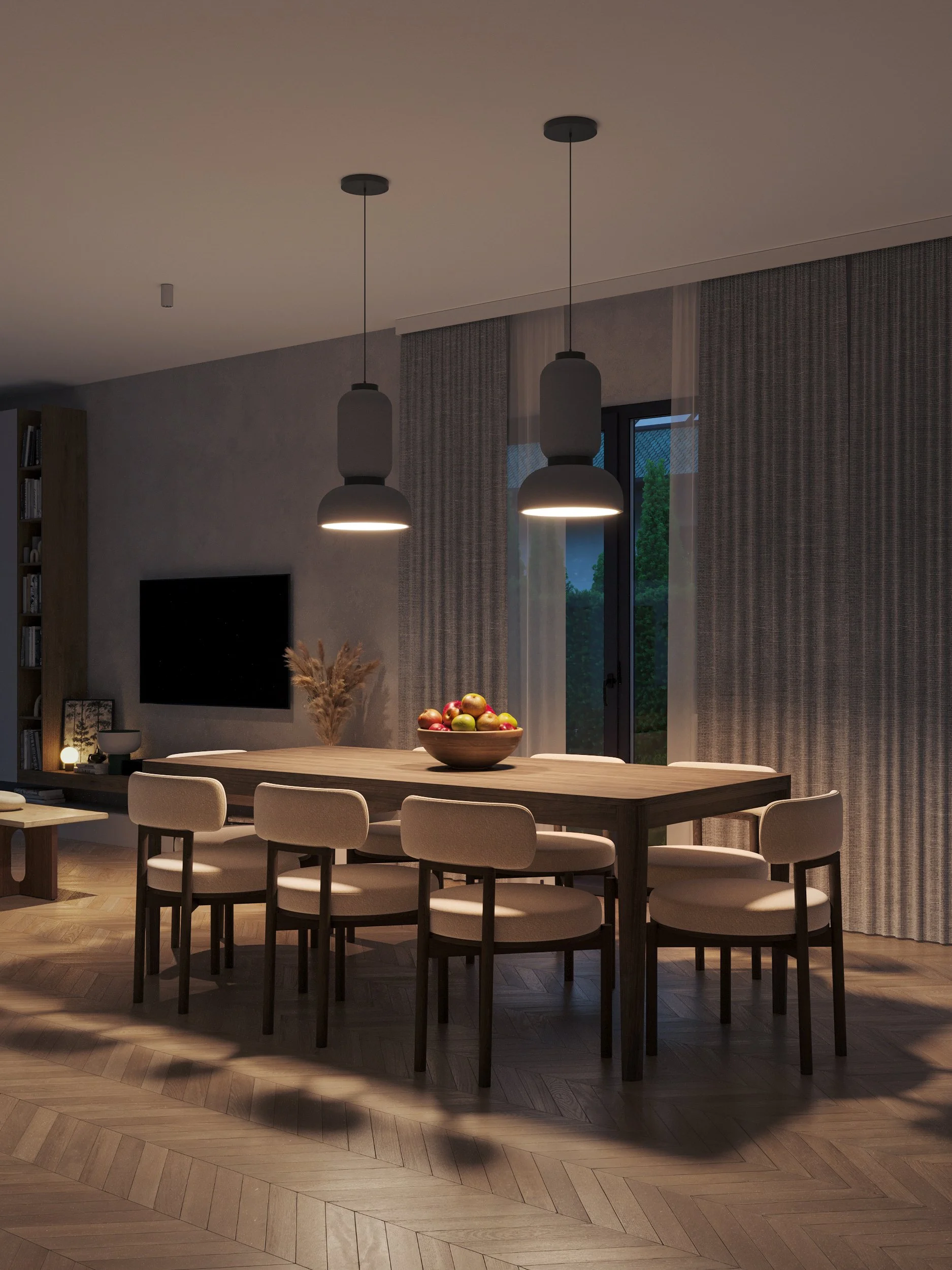The image shows a modern dining area with a large wooden table surrounded by six upholstered chairs, illuminated by two pendant lights hanging from the ceiling. A bowl of fruit serves as the centerpiece, while floor-to-ceiling curtains and soft light
