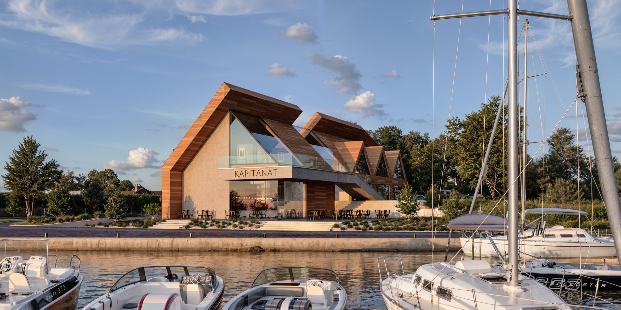 A modern marina building named "Kapitanat" with sharp angular architecture, set beside a calm waterfront lined with yachts and boats. Kamil Rombczyk portfolio architectural vizualization. Kamil Rombczyk portfolio wizualizacje architektoniczne. Wizual