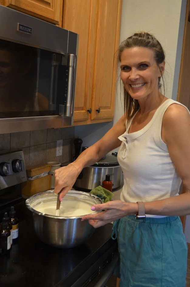 Rhonda is smiling while mixing a large bowl of tallow in the kitchen.