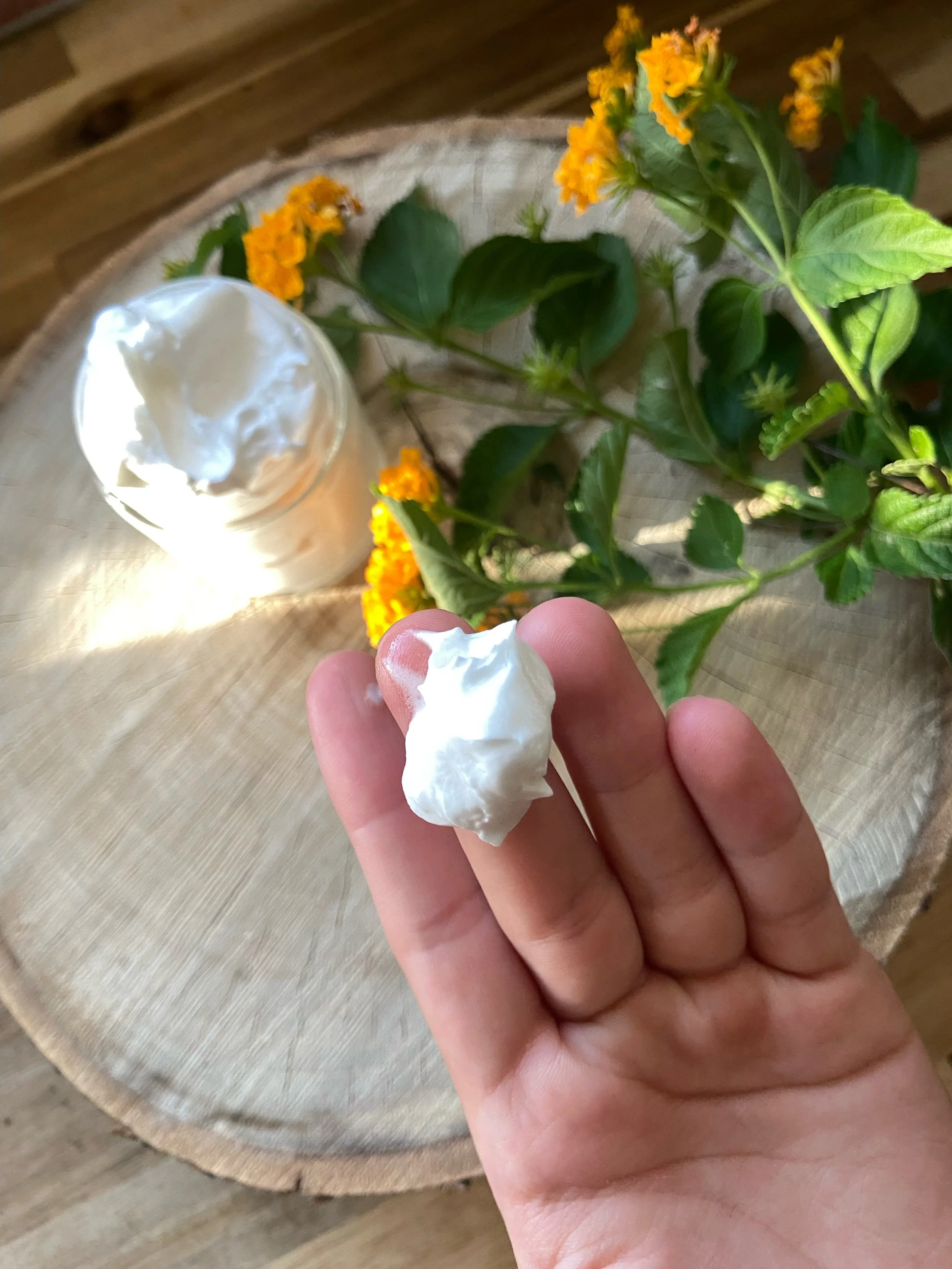 Person applying tallow to the back of their hand.