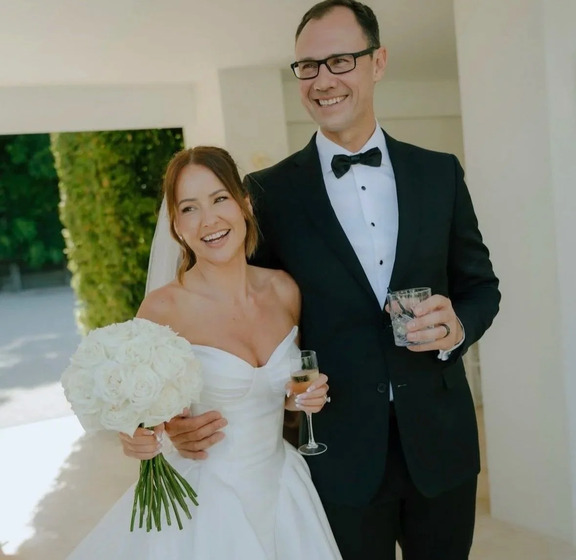 Bride and groom smiling during their wedding ceremony with their celebrant