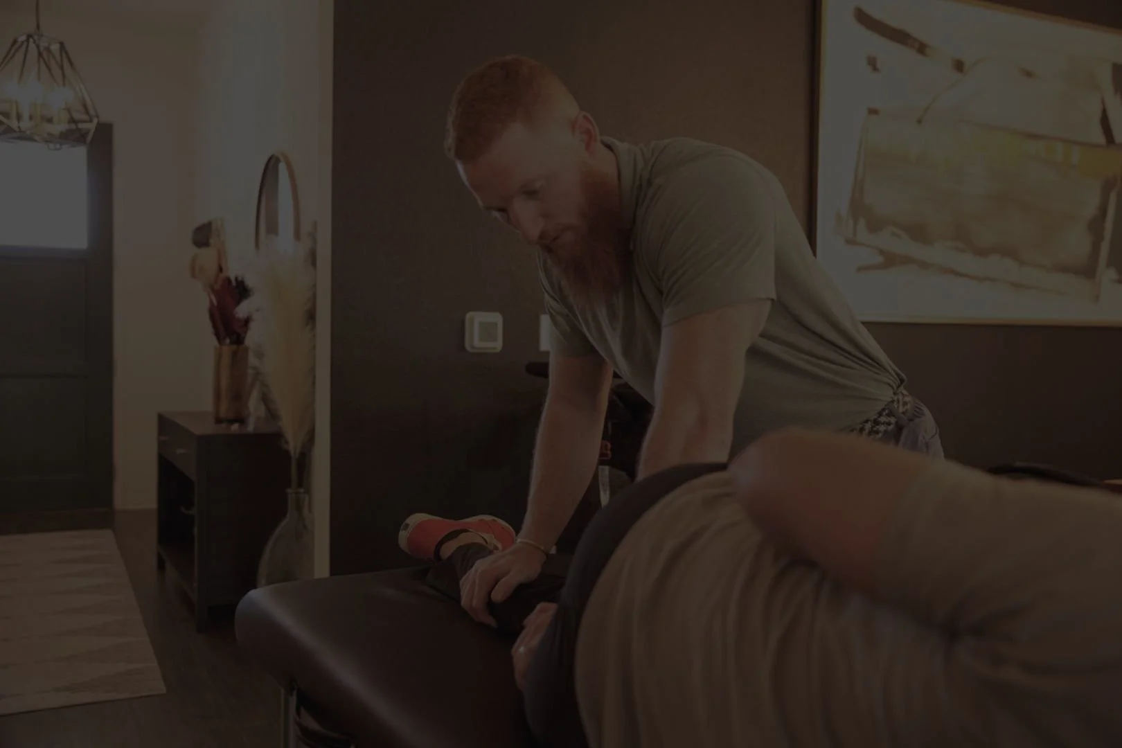 Client receiving physical therapy with Dr. Anthony Winn, founder of PT² and The Weighting Room in a home setting