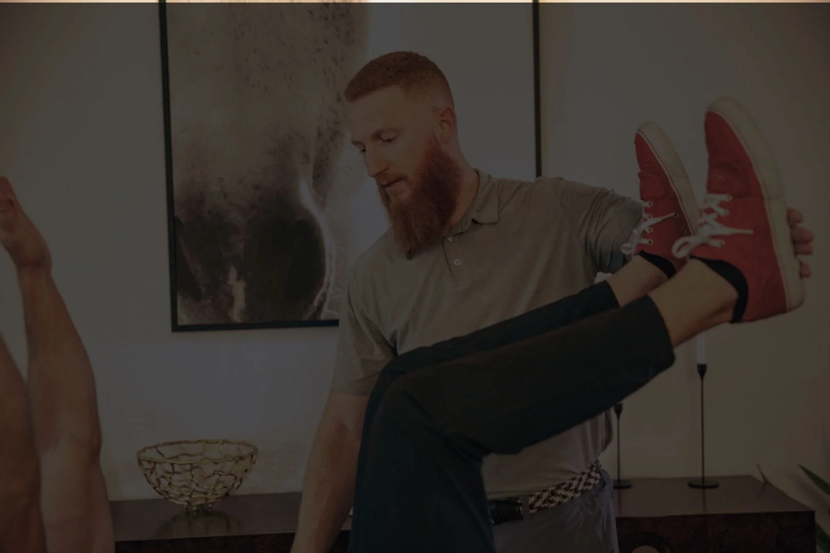 Client receiving physical therapy with Dr. Anthony Winn, founder of PT² and The Weighting Room in a home setting