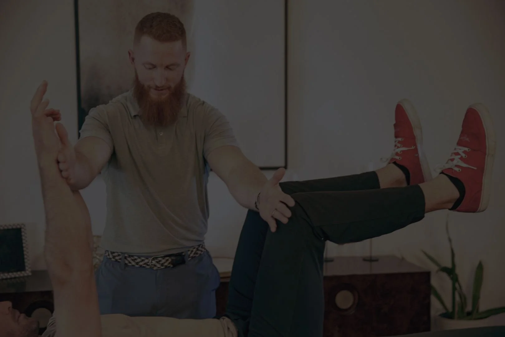 Client receiving physical therapy with Dr. Anthony Winn, founder of PT² and The Weighting Room in a home setting