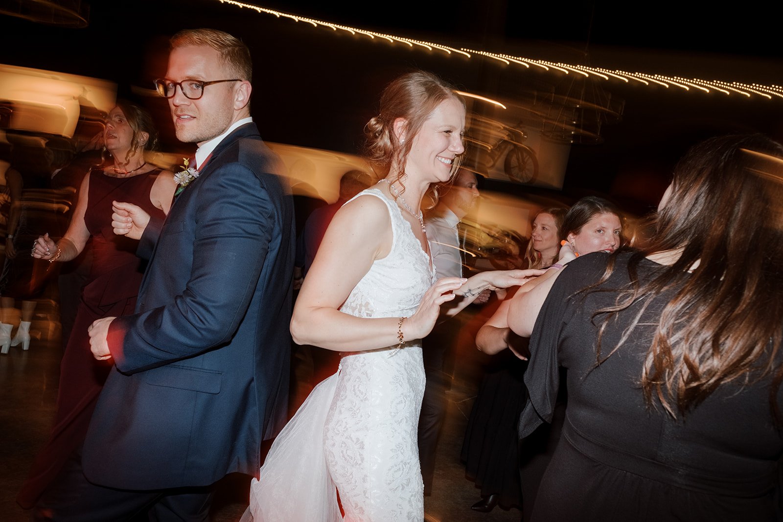 bride and groom dancing with fun colored lights at a wedding hosted in smith and company event space at the moto museum event venue st. louis