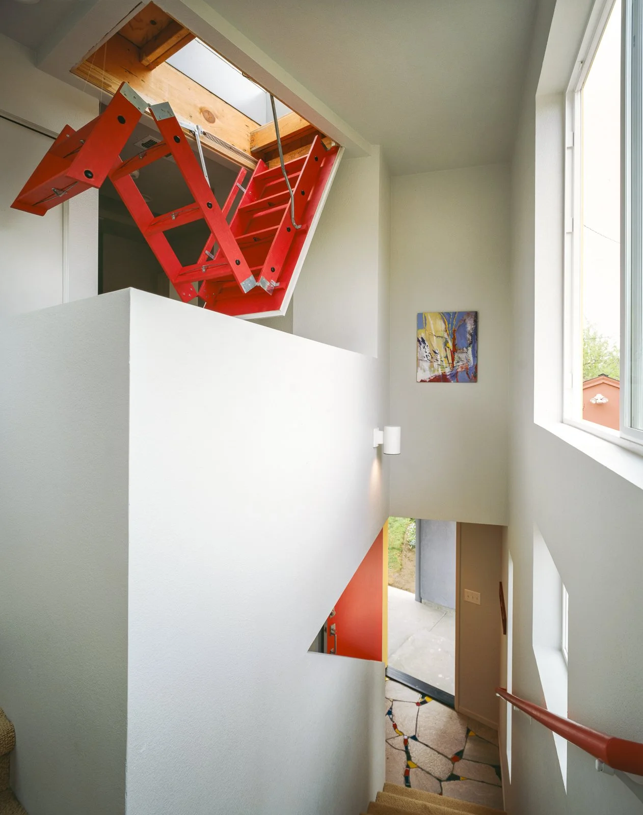 To reach the roof deck, or turret, the tower’s stairwell continues upwards via a fold-out red ladder.