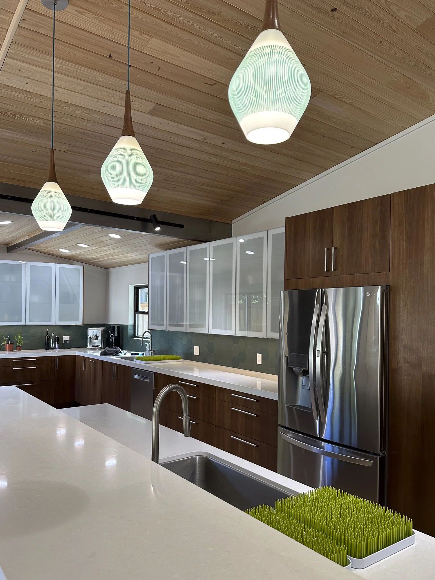 We kept the original pendant lighting fixtures and matched them with green hexagonal tile.