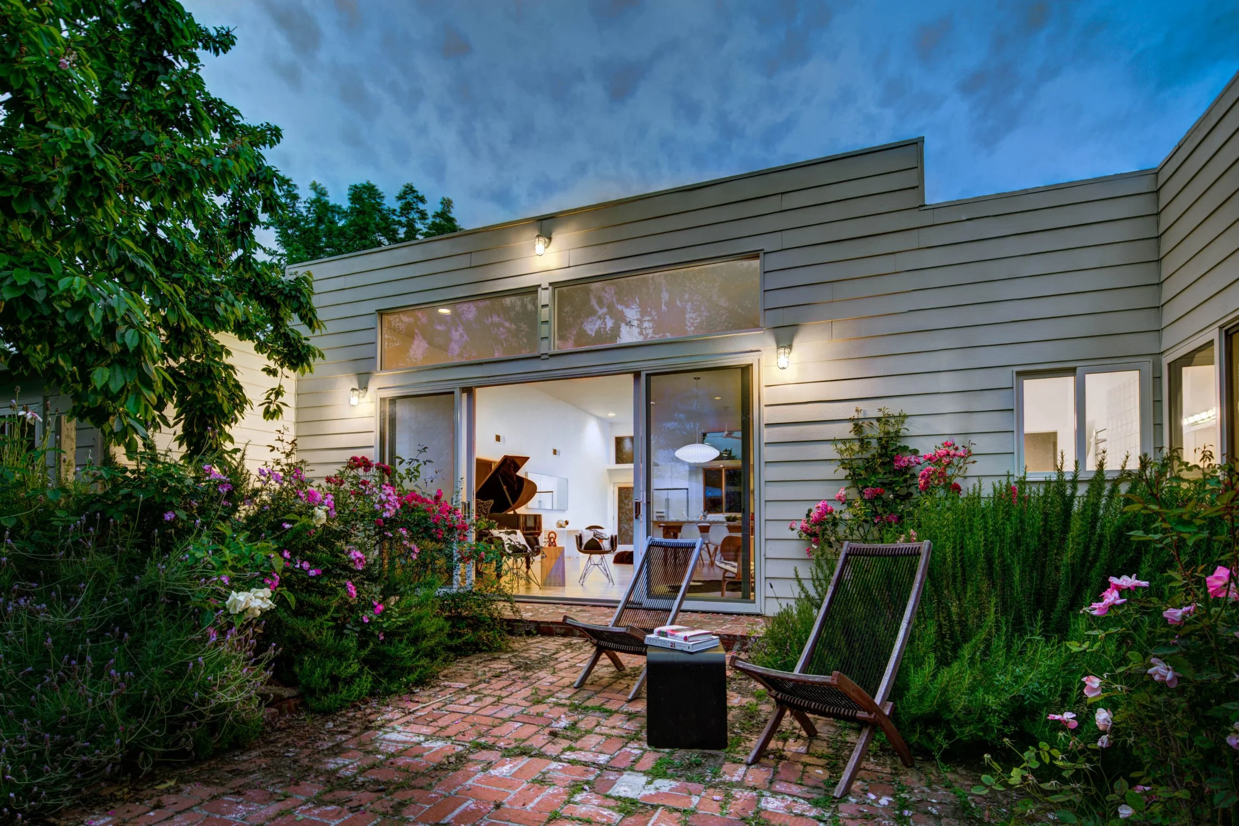 The back of the house spills onto a patio next to the pool, extending the box outdoors on sunny days.