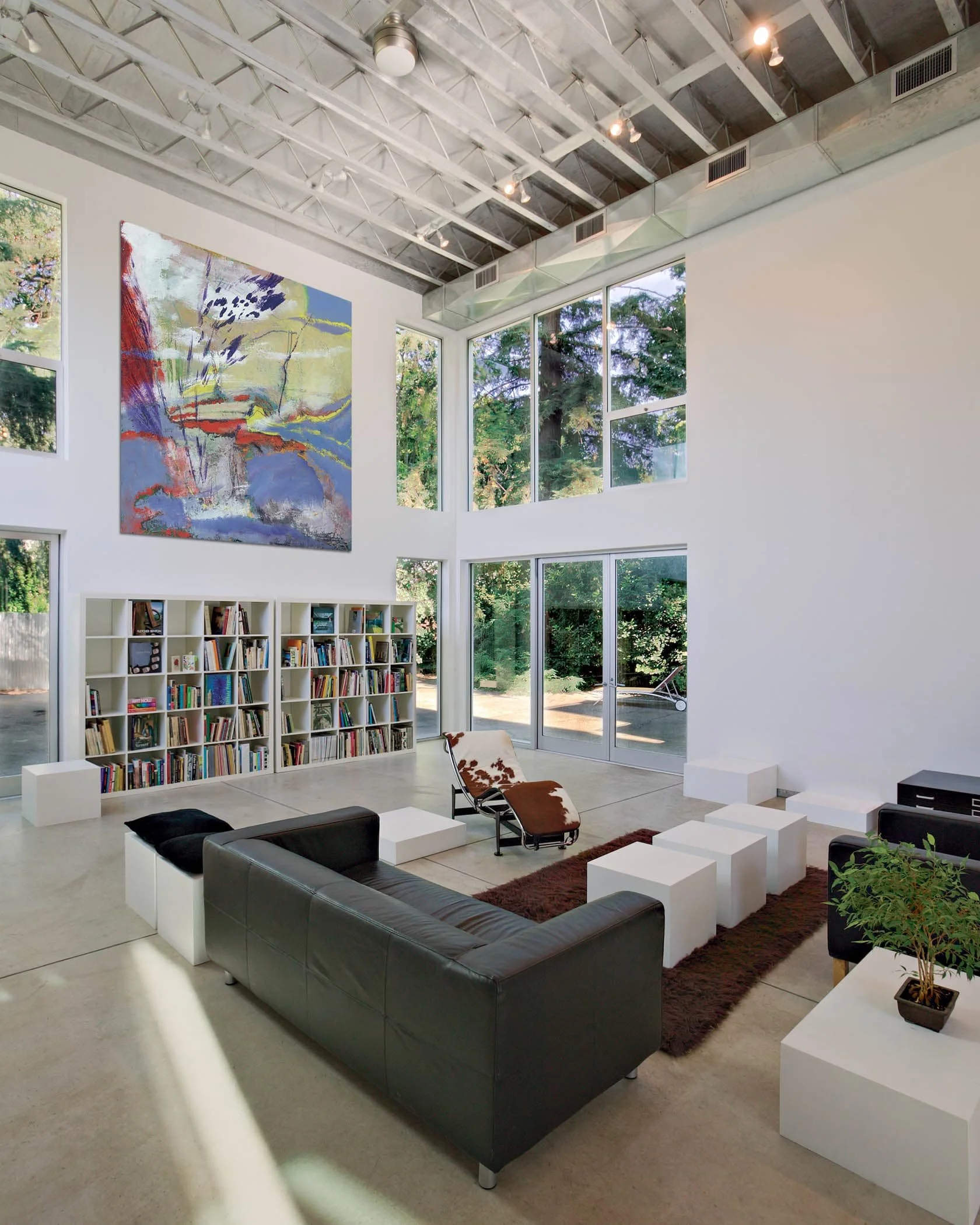 The loft windows are double-height and placed at the corners, framing views of large historic protected trees: a 60-foot tall Deodar cedar and redwood. These heritage trees are increasingly rare in my urban neighborhood, so close to downtown.