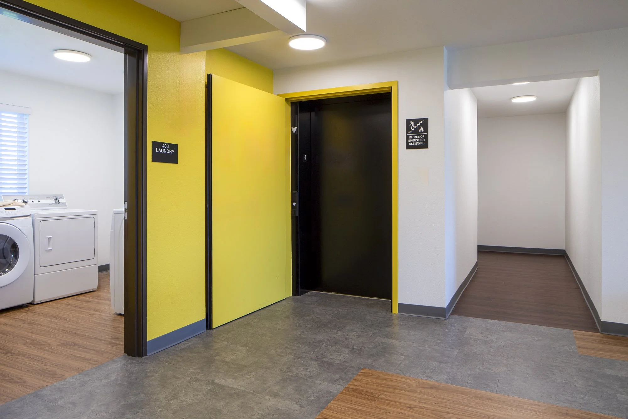 The yellow elevator entrance greets the top two floors' permanent supportive housing residents.