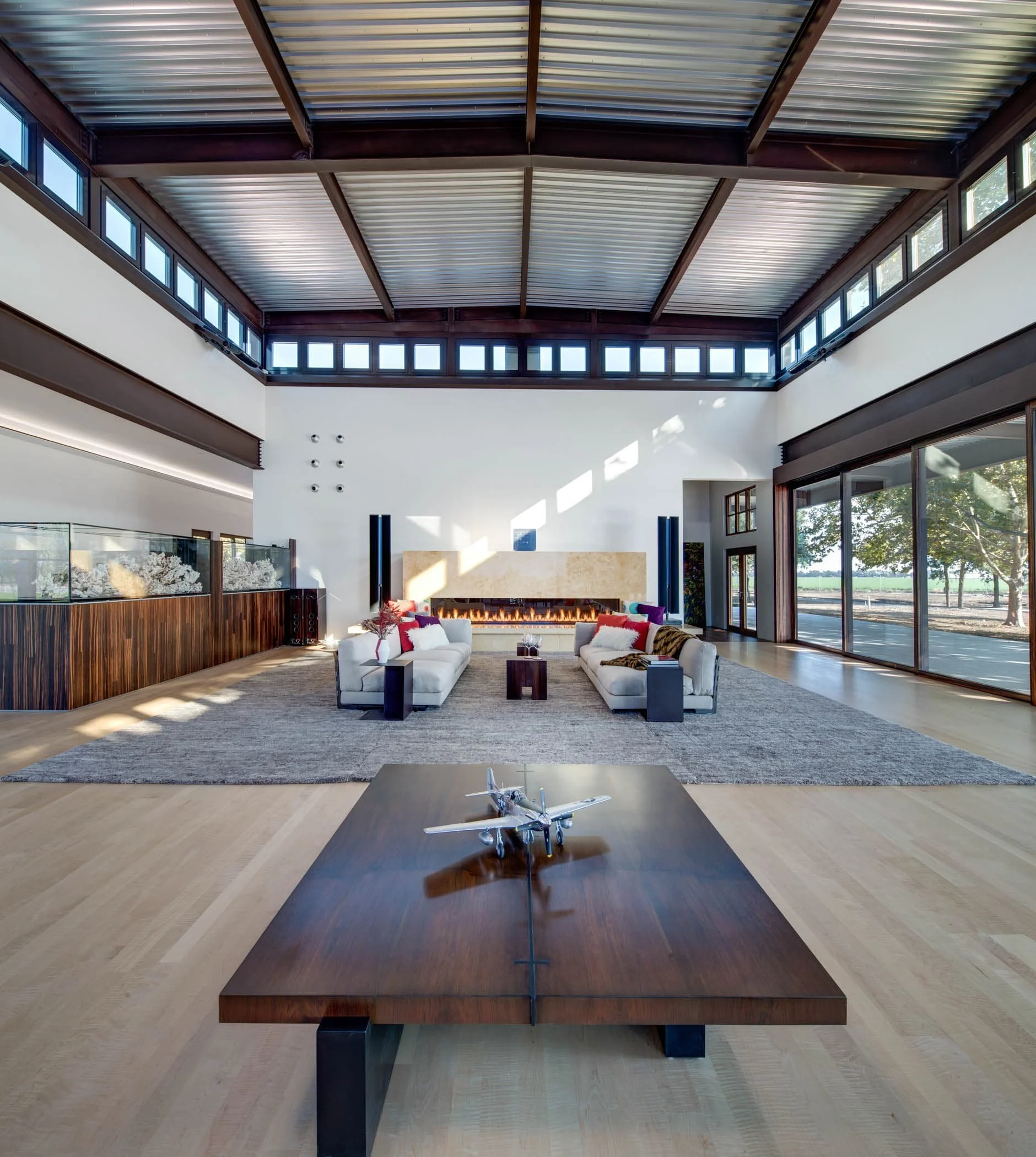 The high, upper layer of square clerestory windows brings more light to the massive spaces. The windows open remotely to provide ventilation and darken to provide shade.