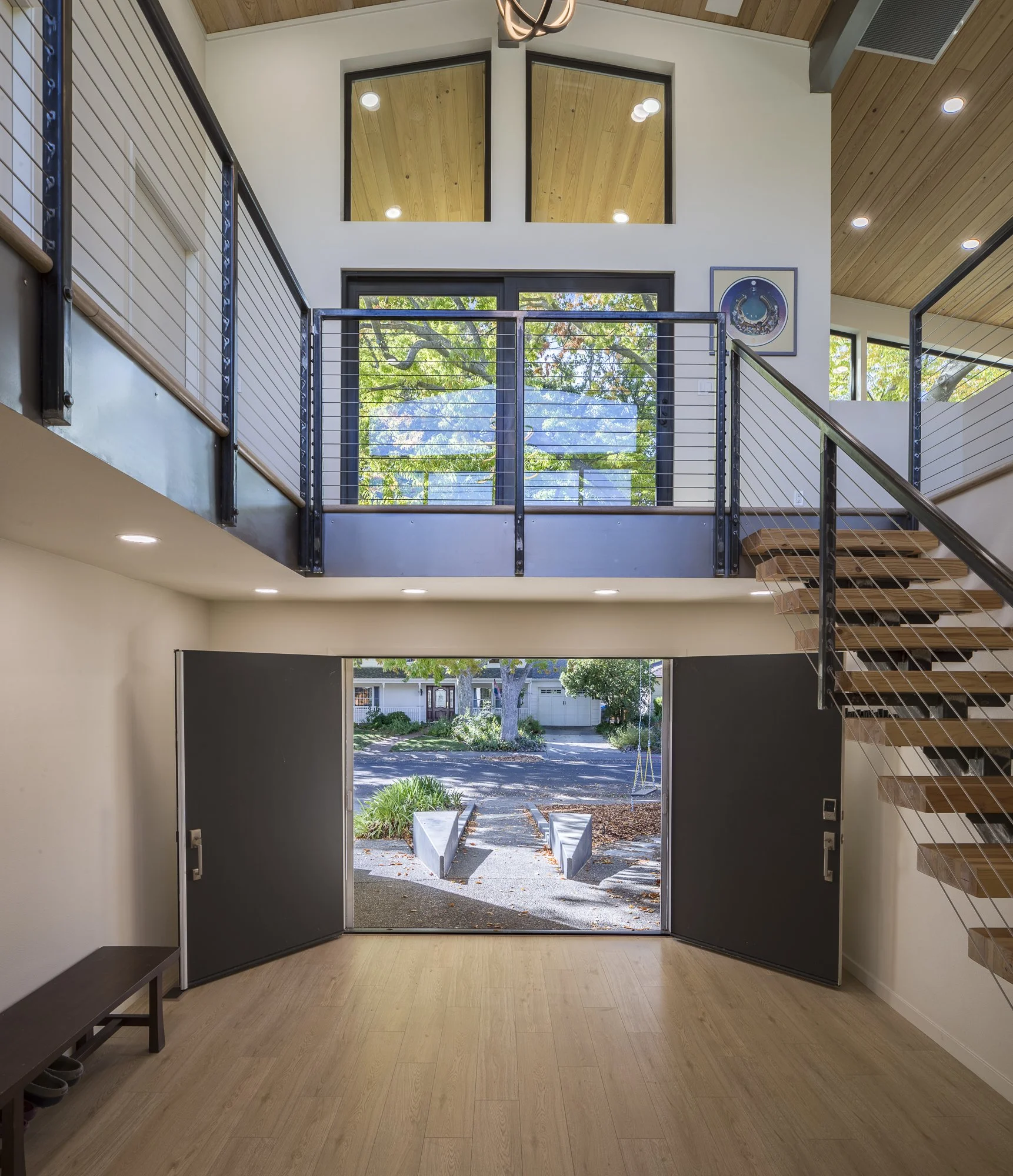 Sequential thresholds and transitions exist throughout this project. For instance, the front entry’s exposed granite path has angled concrete forms embedded with Mexican pebbles on either side, doubling as informal seating areas and marking transitio