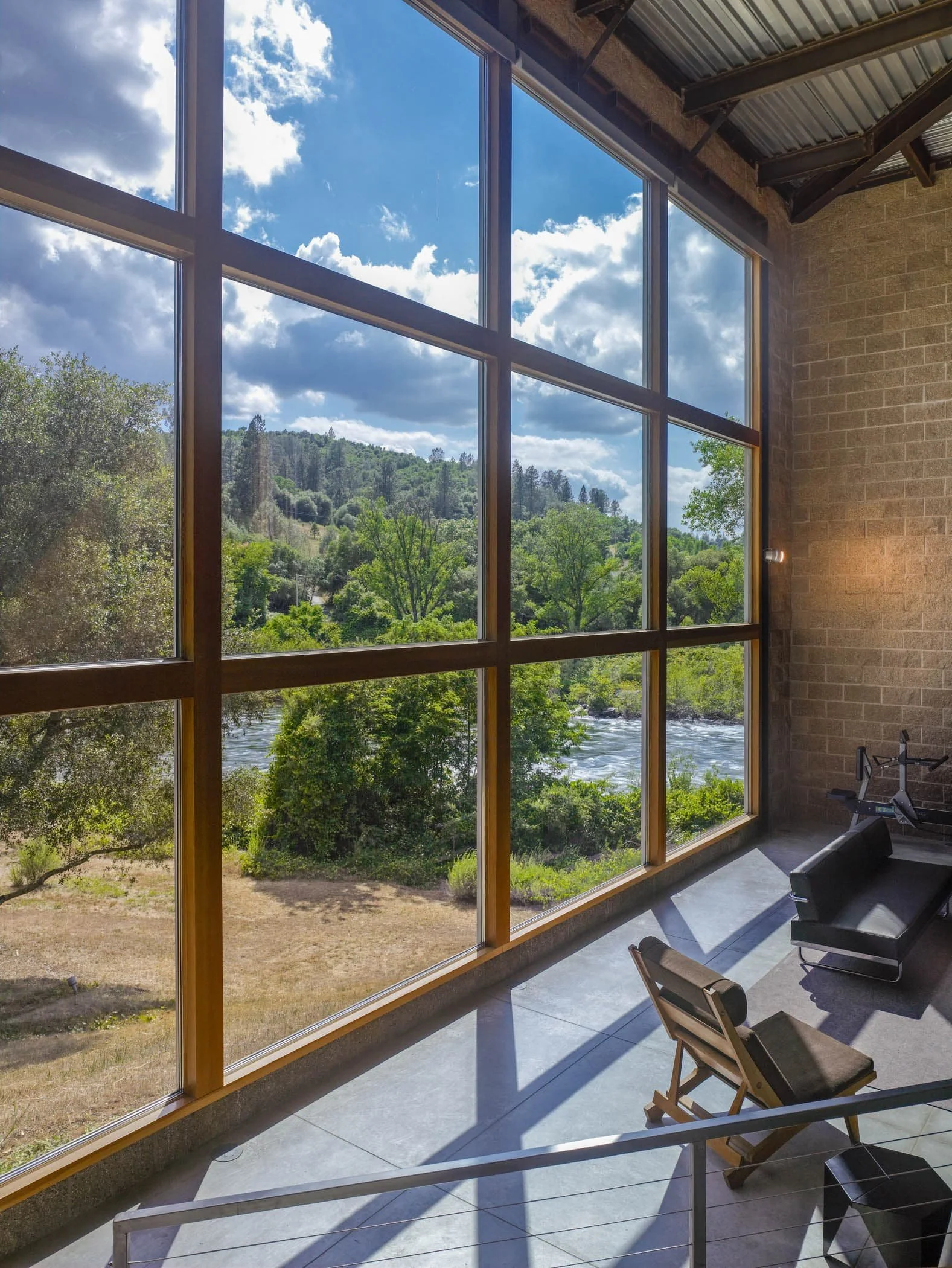 The 18-foot-high living room window is visible from the living room, dining room, kitchen, and second-floor study.