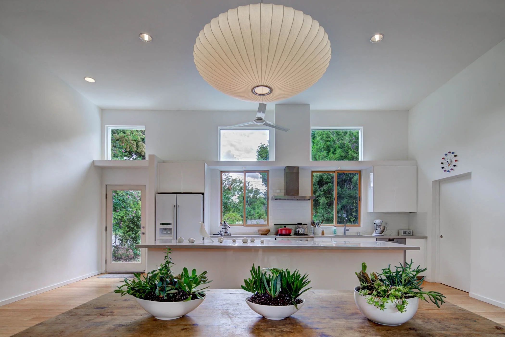 The great room serves kitchen, dining, living, and creative functions.