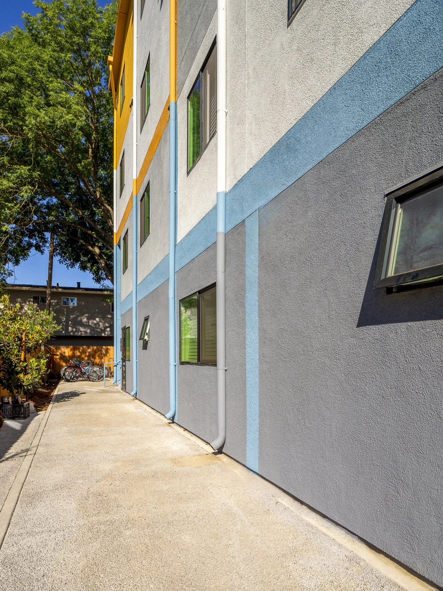 A private blue entrance at the side of the building gives short-term residents independence.