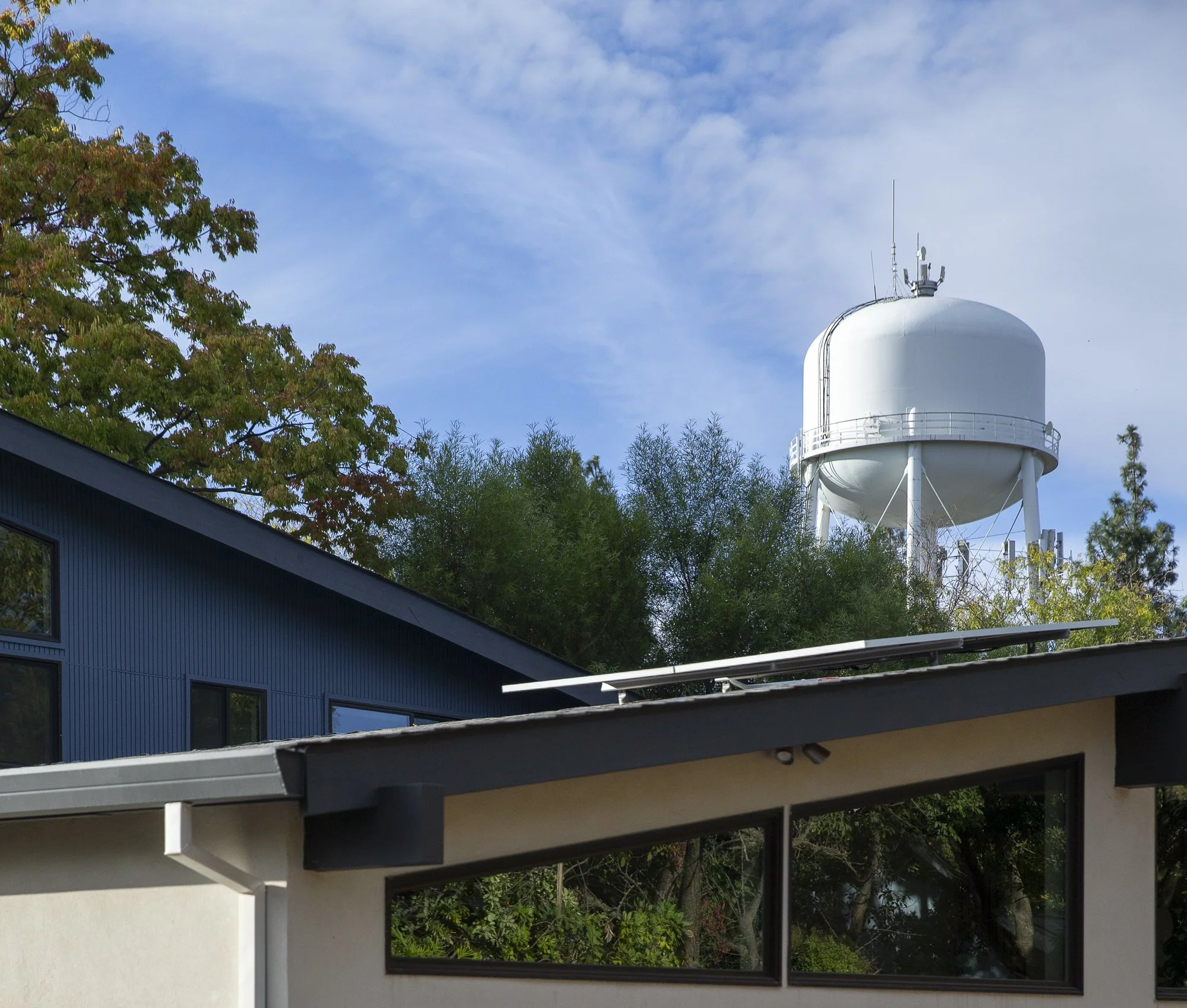One of Davis' iconic water towers stands tall, visible from the backyard above the home's rooflines.