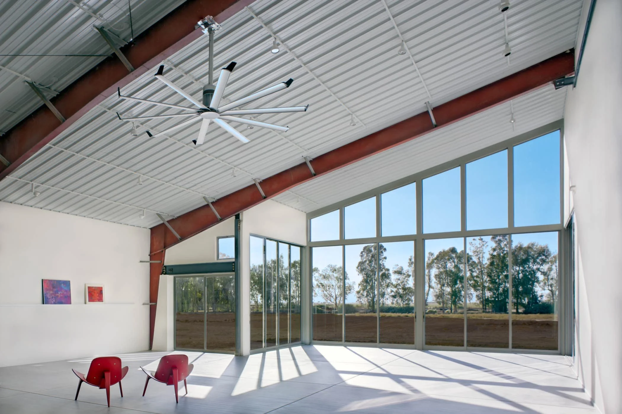 The tall, wide window bay frames the meeting of sky and land, creating a living art piece: a tableau of daily and seasonal changes.
