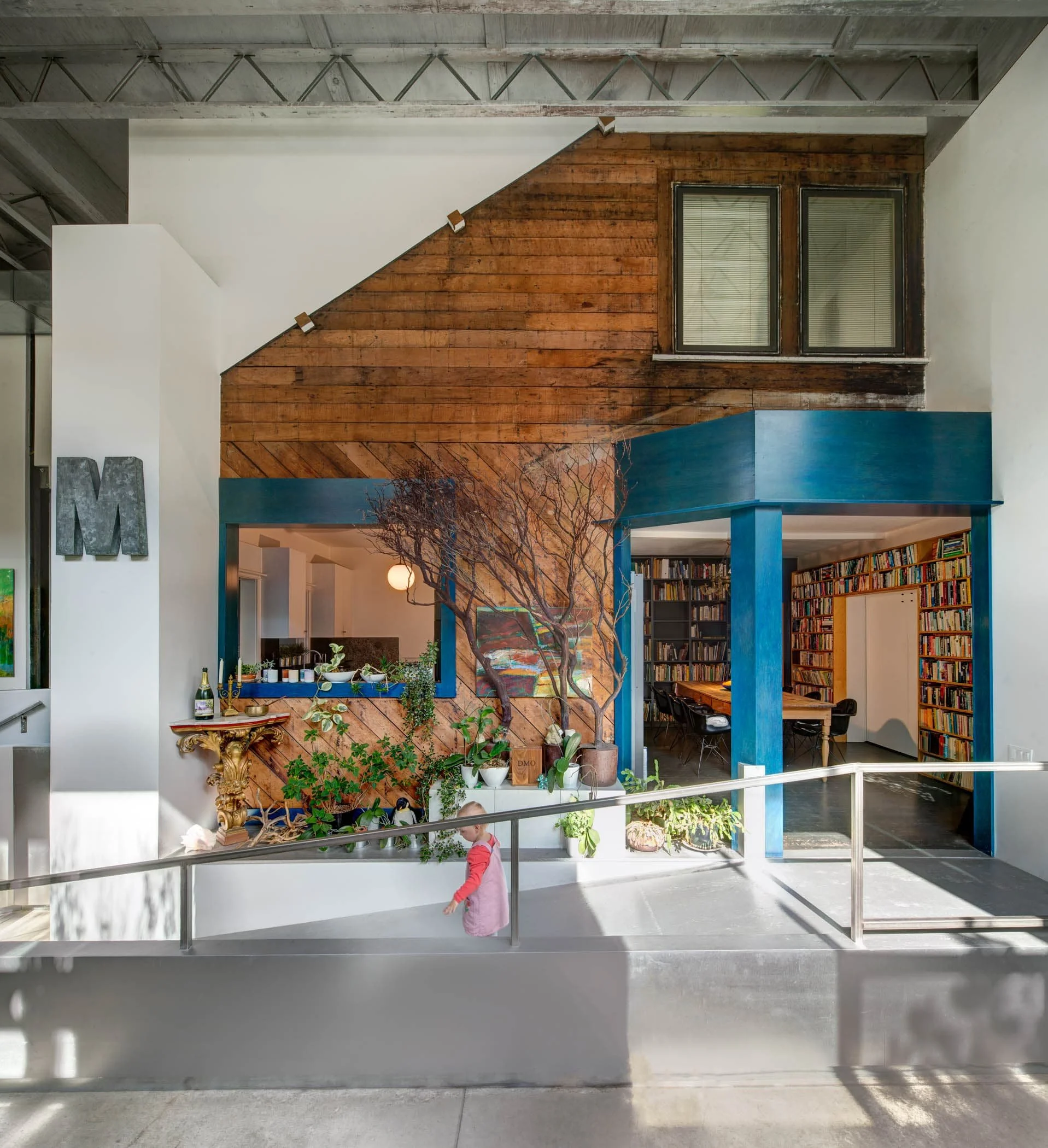 Where we punched through the bungalow, I exposed the old wall, framing the openings in bright blue stained wood.