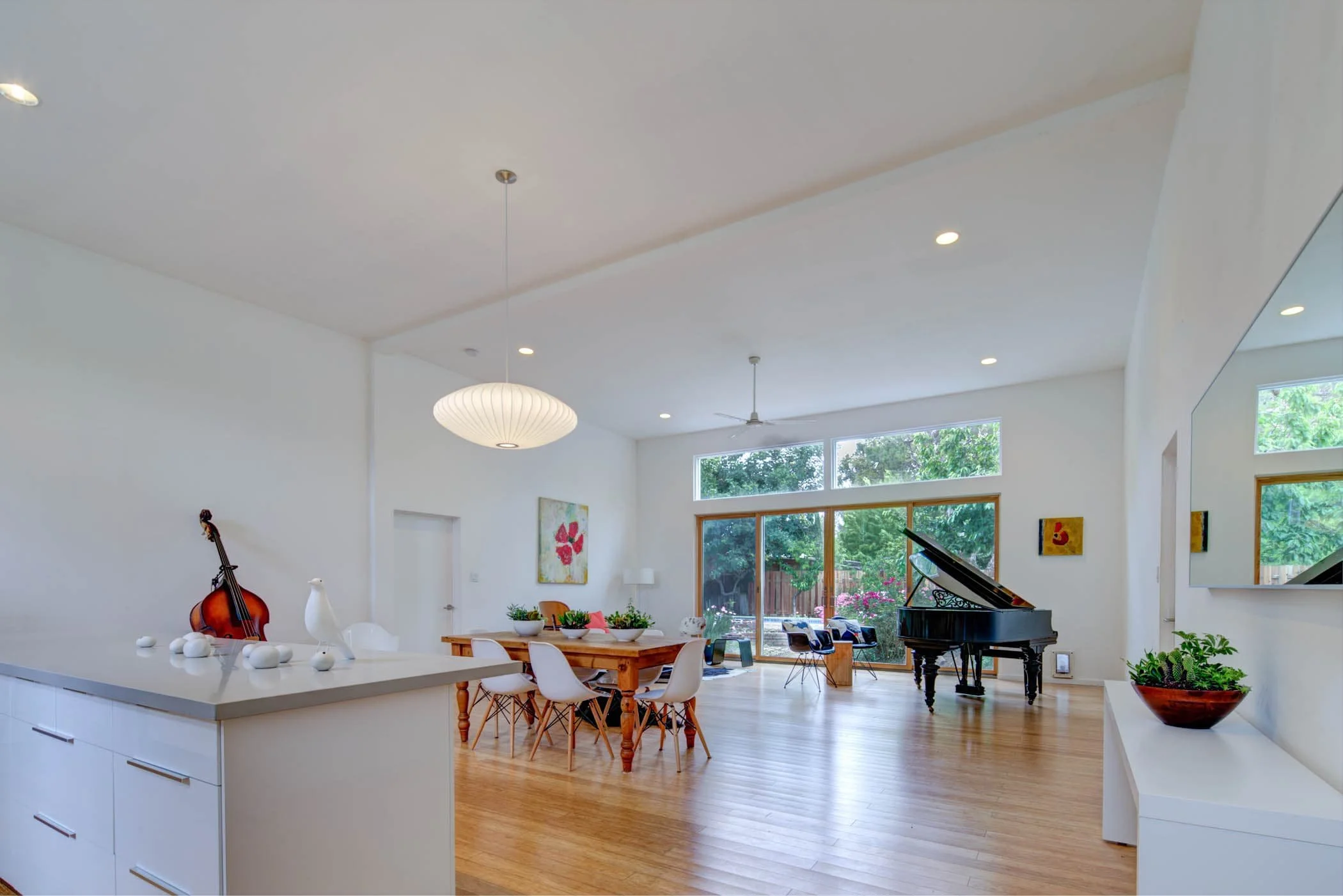 The piano sits at one corner of the space, perfect for impromptu performances and contemplating the plants and sky for inspiration.