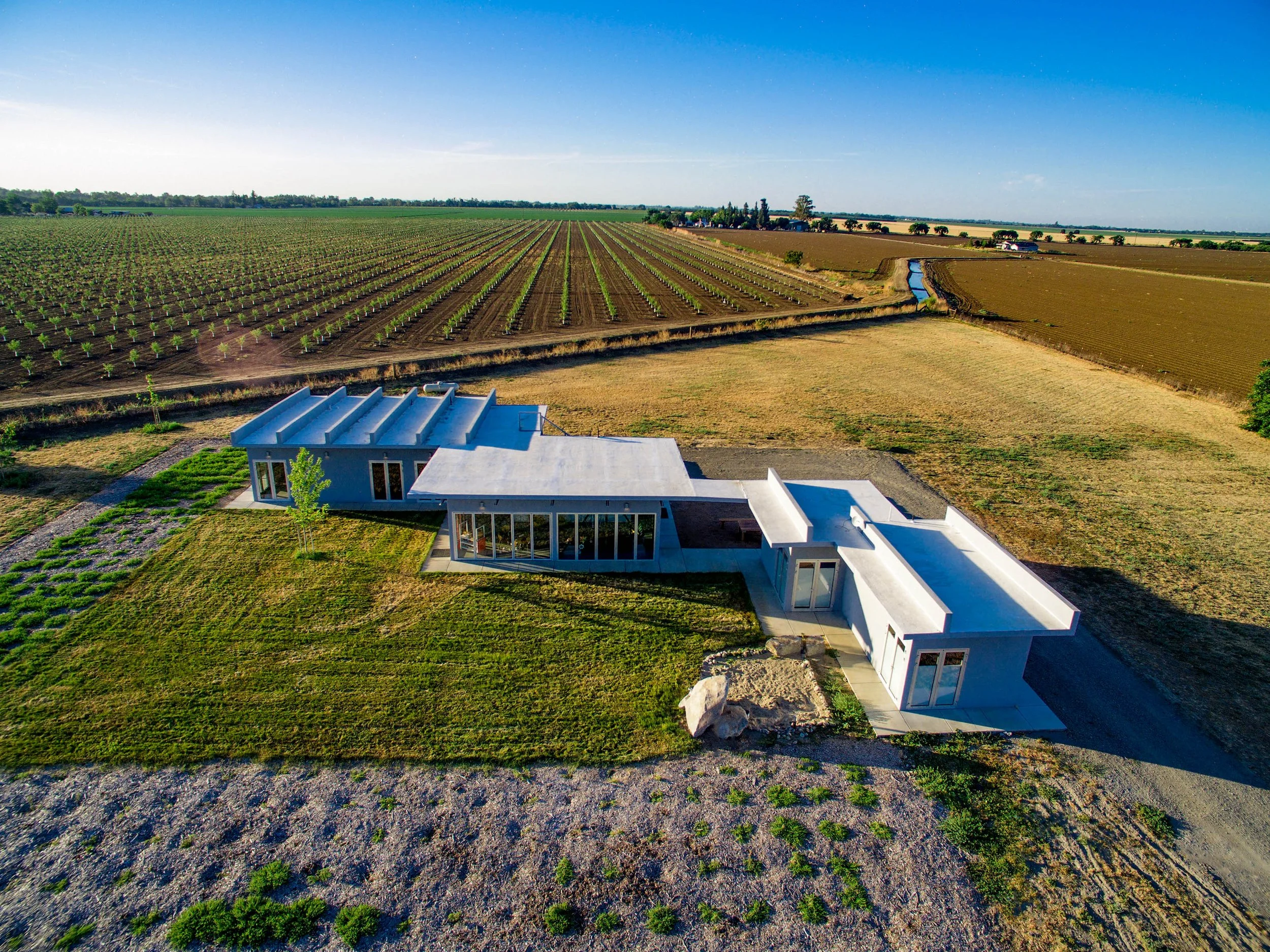 The wings visually extend the neighboring crop rows.