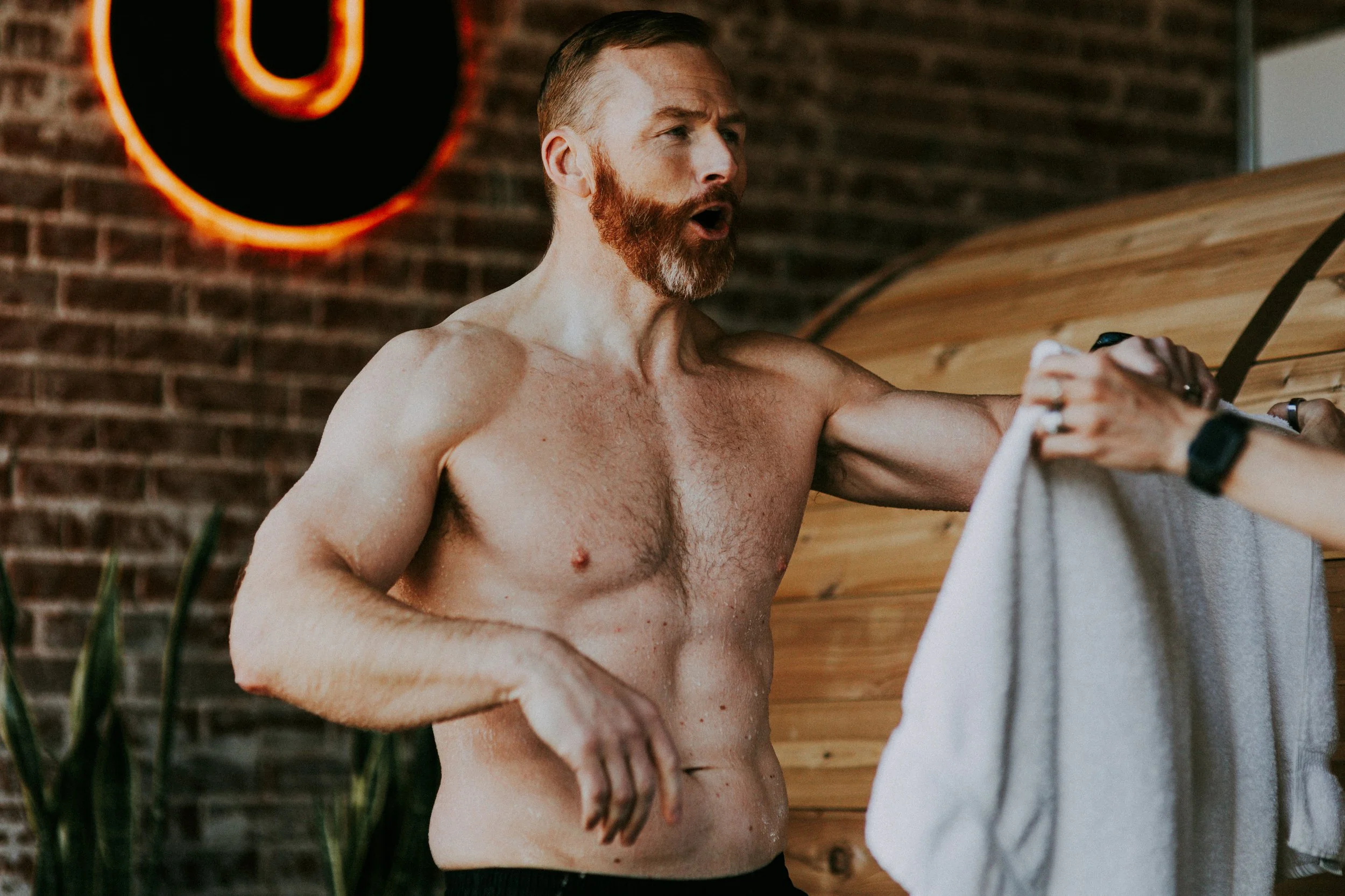Man doing cold plunge and traditional sauna in Denver, CO