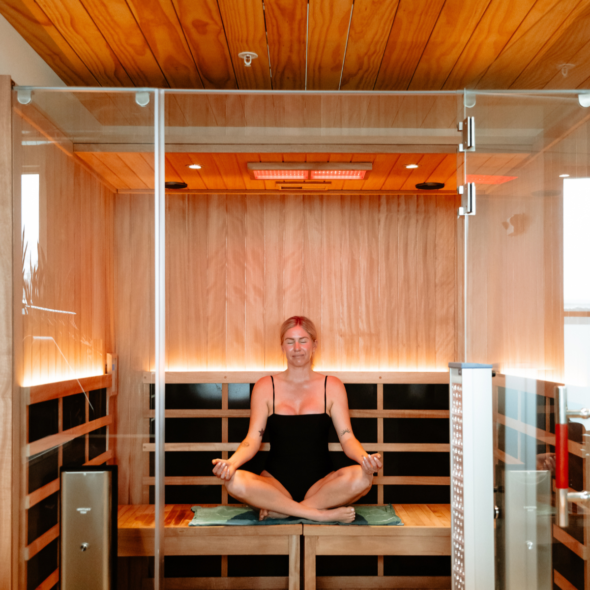 Woman doing infrared sauna and red light in Denver, CO