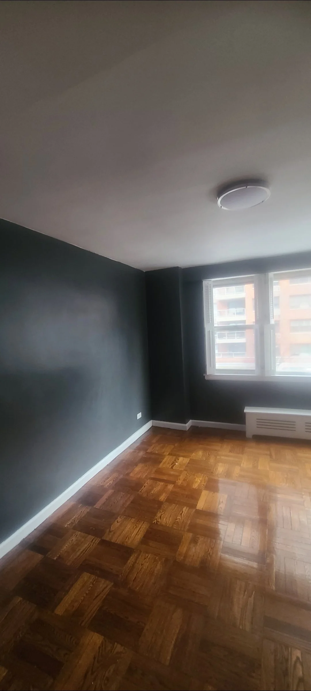 Bedroom with Dark grey walls prior to fresh coat of white paint