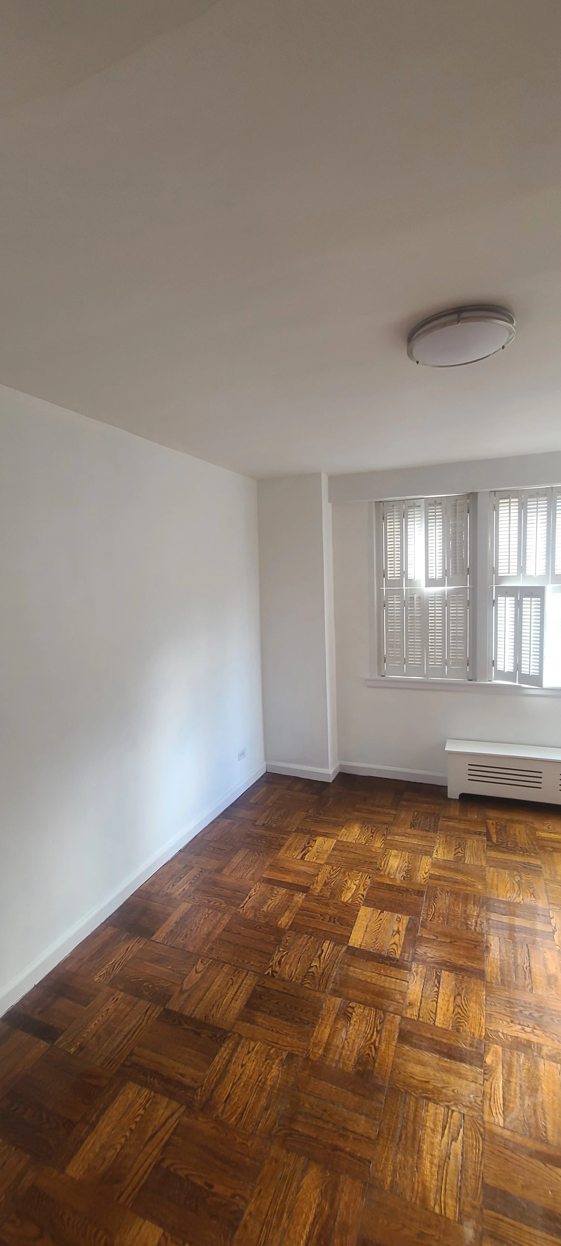 Freshly painted white room with brown wooden floors