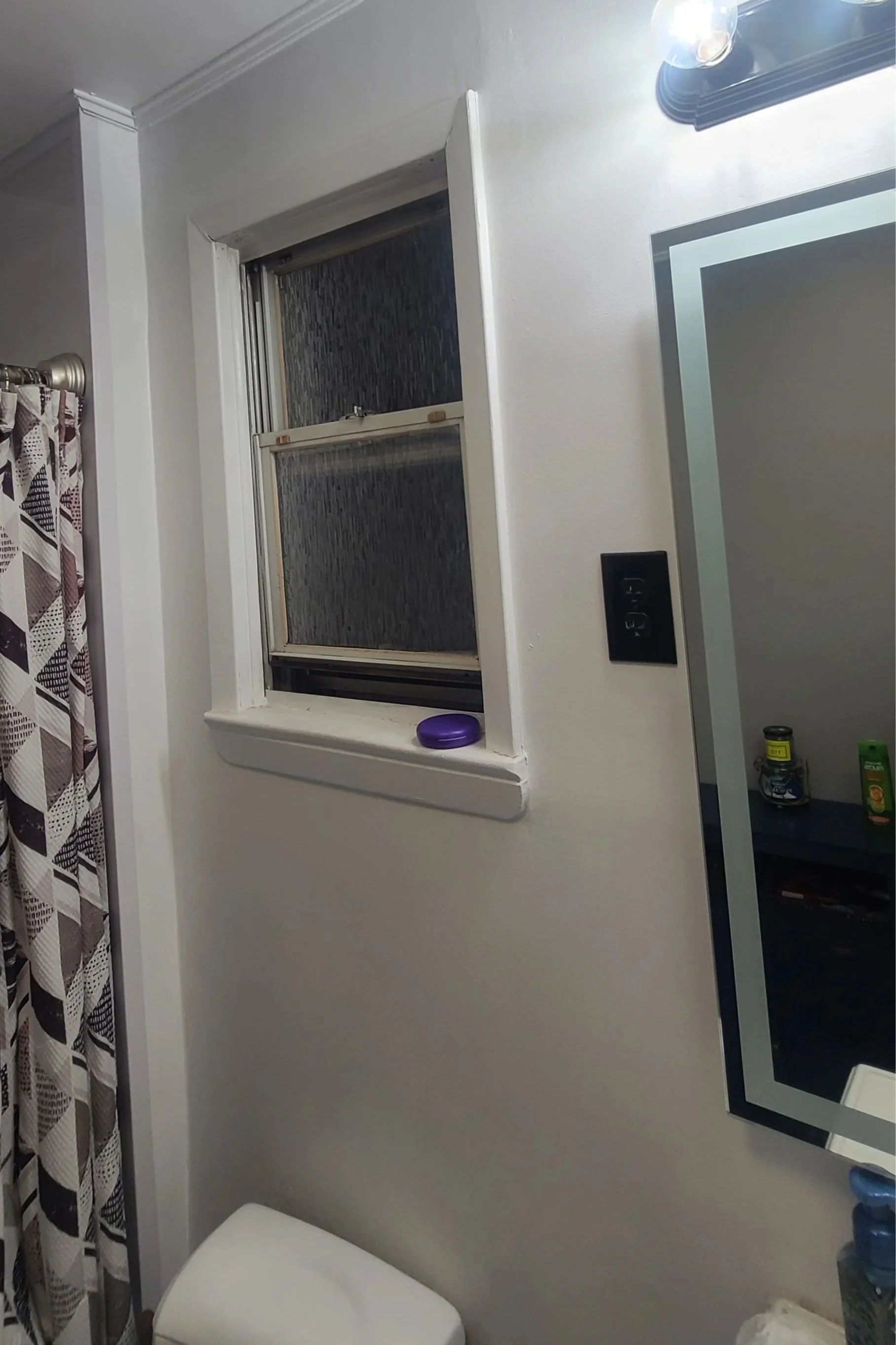 White bathroom wall with mirror and sink