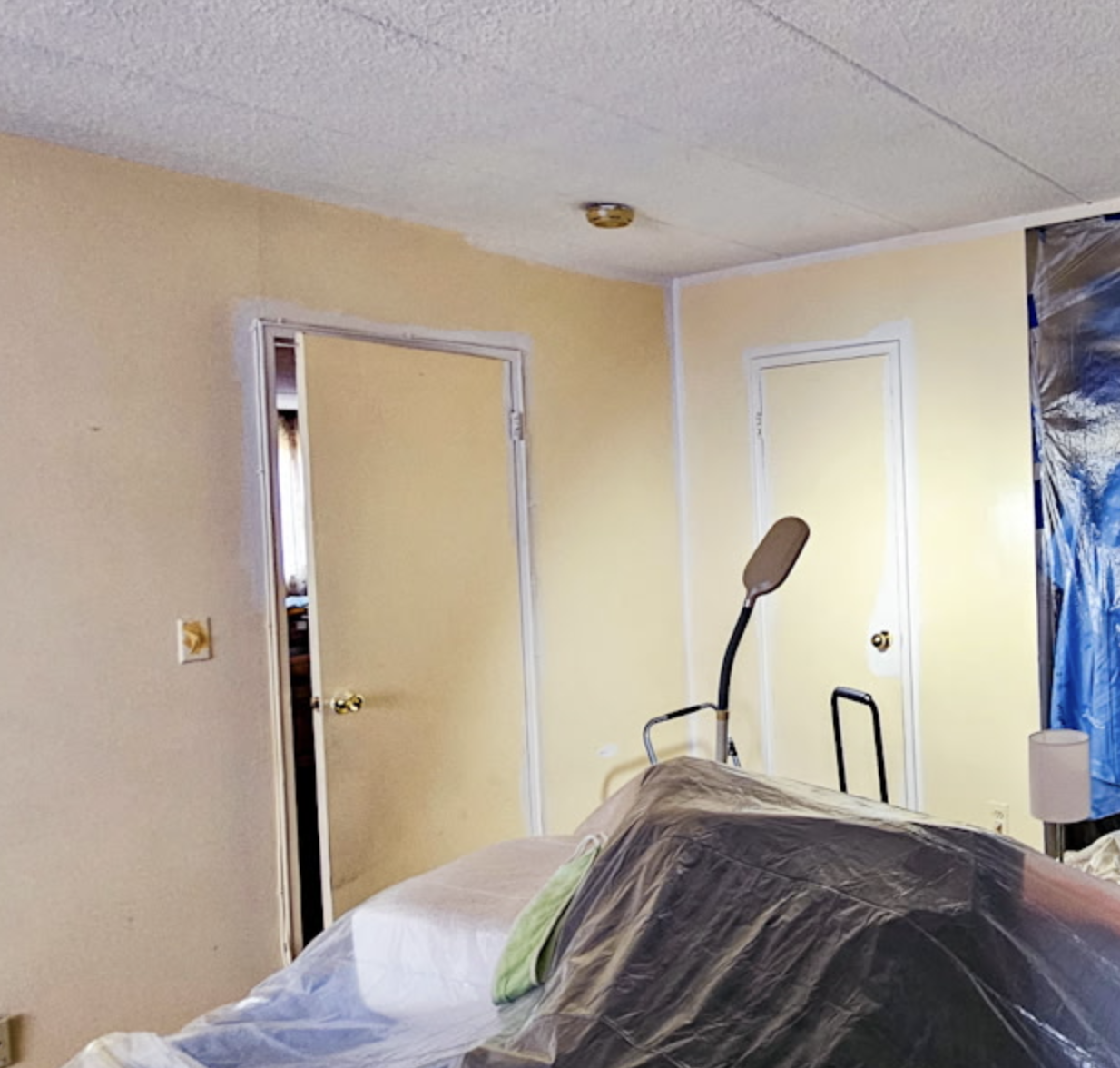 Two yellow doors with golden doorknobs