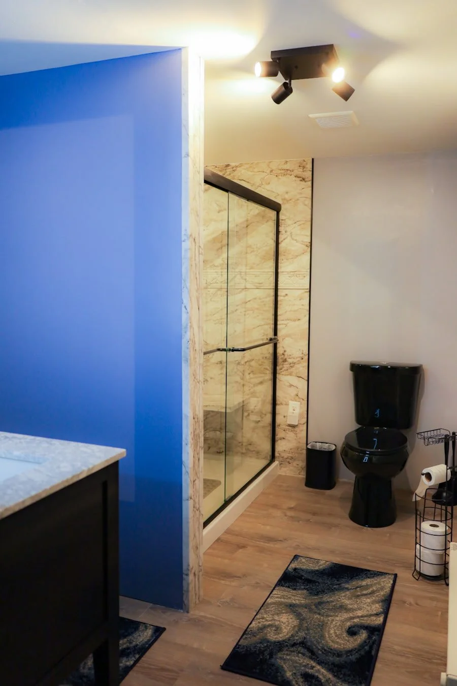 Black toilet in a finished bathroom, after the room was painted grey