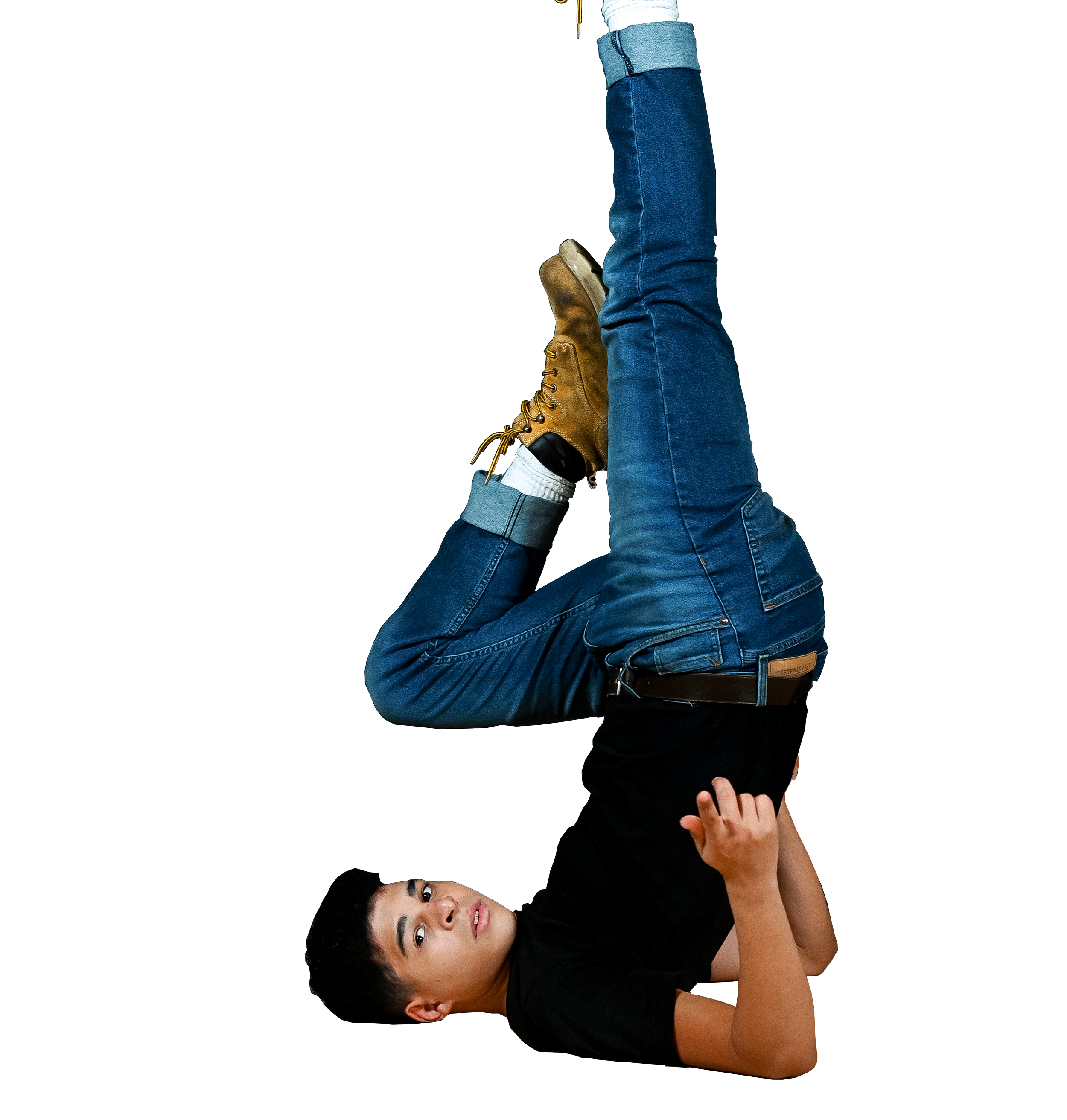 Jack Cipriani doing a back shoulder freeze, wearing blue jeans, a black shirt, and brown boots.